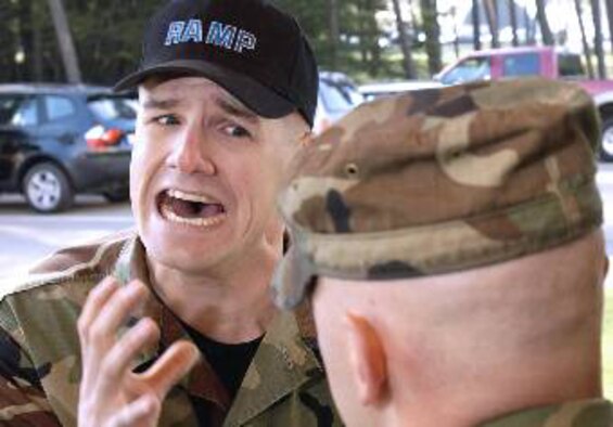 Staff Sgt. Mike Bowles struggles to understand a candidate at Ramstein's Area Motivational Program. Sergeant Bowles "motivation" method is similar to what Airman Joshua Clendening, 317th Maintenance Squadron, endured during his time at Lackland Air Force Base, Texas, in March 2007. This 30-day program is used by commanders to "reblue" airmen basics through staff sergeants whose attitude or behavior has deteriorated, resulting in nonjudicial punishment. Ramstein's program was open from Jan. 2004 to March 2007. Lackland Air Force Base, Texas, and Keesler Air Force Base, Miss., are now the only Air Force bases that host remotivation programs. (U.S. Air Force photo by Master Sgt. John E. Lasky) 
