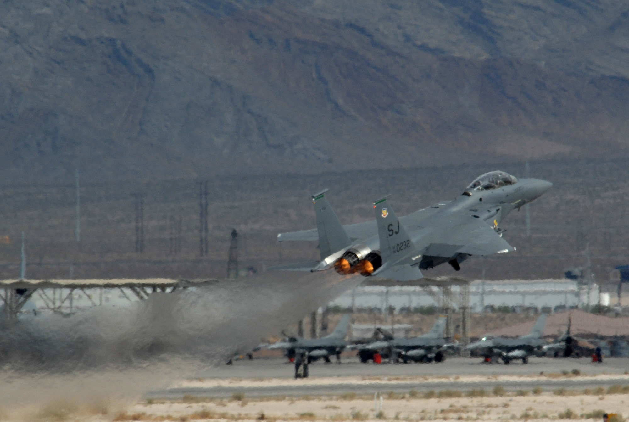 An F-15E Strike Eagle, takes off during Exercise Green Flag April 24 at Nellis Air Force Base, Nev. Green Flag is an Air Combat Command pre-deployment exercise for units who perform close-air support. The training exercise, which began April 19 and runs through May 4, mirrors many of the irregular warfare-conditions the aircrews will see while fighting the war on terrorism. During Green Flag, aircrews will try to learn better ways to employ airpower within an irregular warfare environment. The F-15E is from Seymor Johnson AFB, N.C. (U.S. Air Force photo/Master Sgt. Kevin J. Gruenwald)
