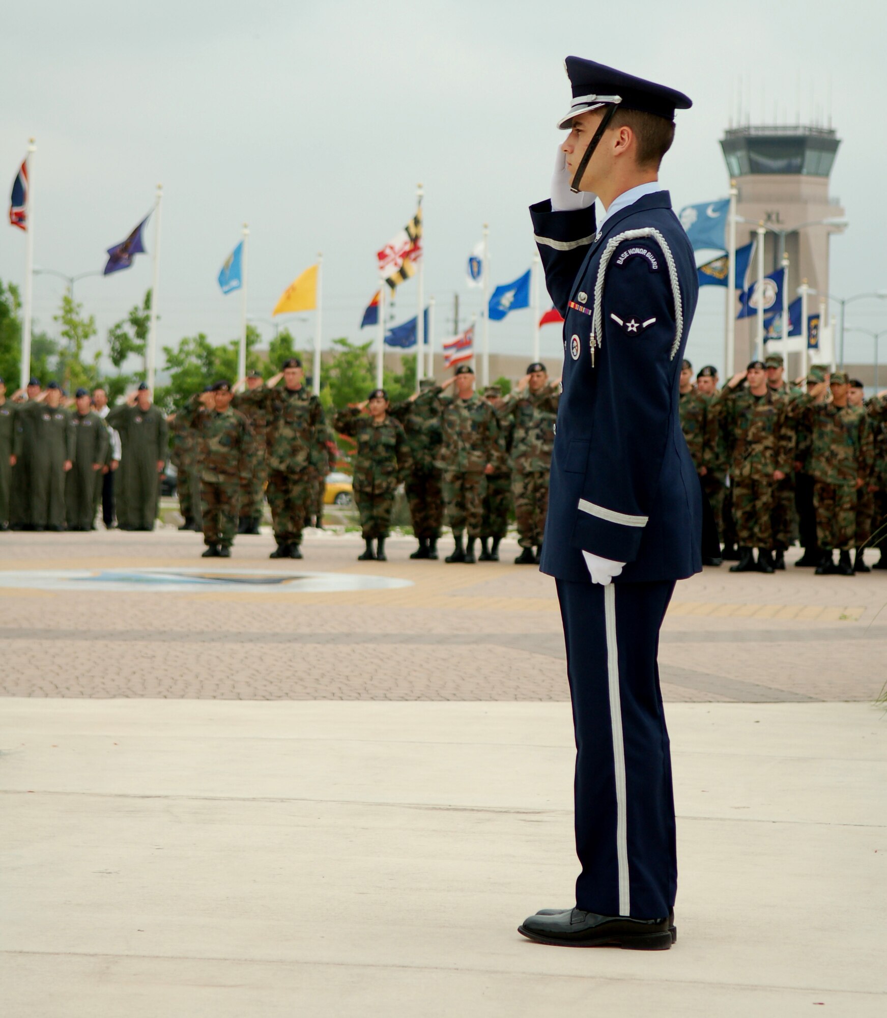 LAUGHLIN AIR FORCE BASE, Texas -- Airman Eddie Cimmino salutes the U.S. flag as it is flown at half-staff for Senior Airman Juan Navarro, a fallen troop we recently lost to a traggic accident, April 24, 2007. 