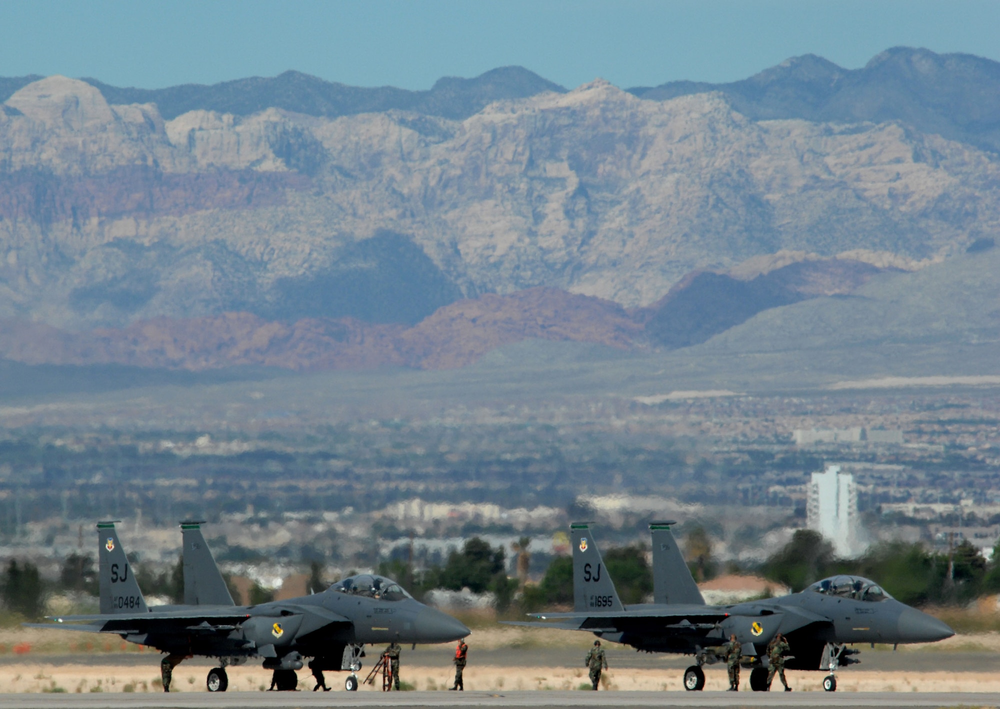 Two F-15E Strike Eagles prepare to launch in support of Exercise Green Flag April 24 at Nellis Air Force Base, Nev. Green Flag is an Air Combat Command pre-deployment exercise for units who perform close-air support. The training exercise, which began April 19 and runs through May 4, mirrors many of the irregular warfare-conditions aircrews will see while fighting the war on terrorism. During Green Flag, aircrews will try to learn better ways to employ airpower within an irregular warfare environment. The F-15Es are from Seymor Johnson AFB, N.C. (U.S. Air Force photo/Master Sgt. Kevin J. Gruenwald) 
