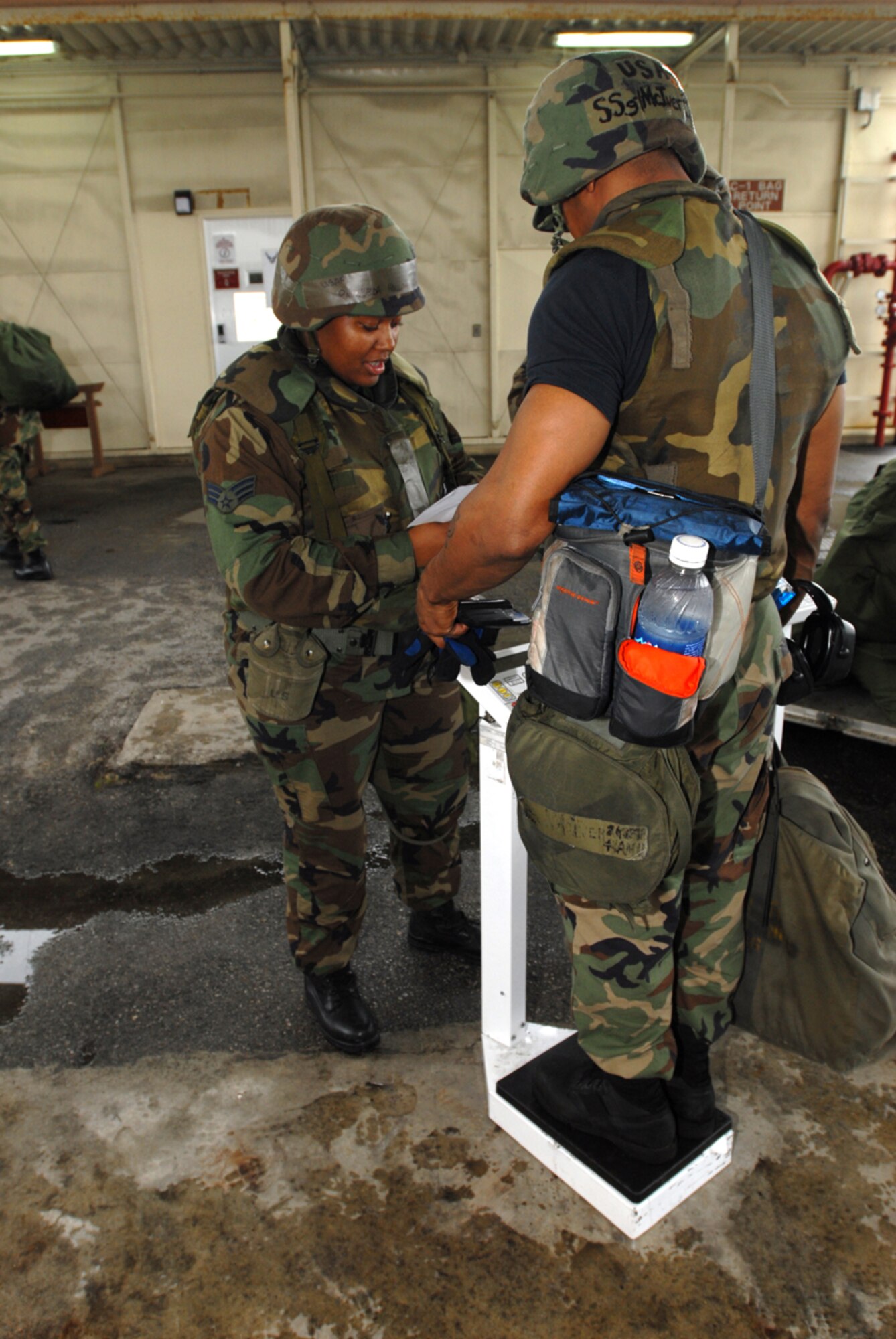 070424-F-3622Z-012
KADENA AIR BASE, Japan -- Senior Airman Rasheeda Hollingsworth, 18th Logistics Readiness Squadron, weighs in Staff Sgt. Christopher McIver, 18th Aircraft Maintenance Squadron, at the Kadena Installation Deployment Readiness Center.  This was part of week-long exercise activities designed to test the wing's ability to mobilize personnel and cargo, respond to crises, and project combat airpower. (U.S. Air Force/Airman 1st Class Kasey Zickmund)