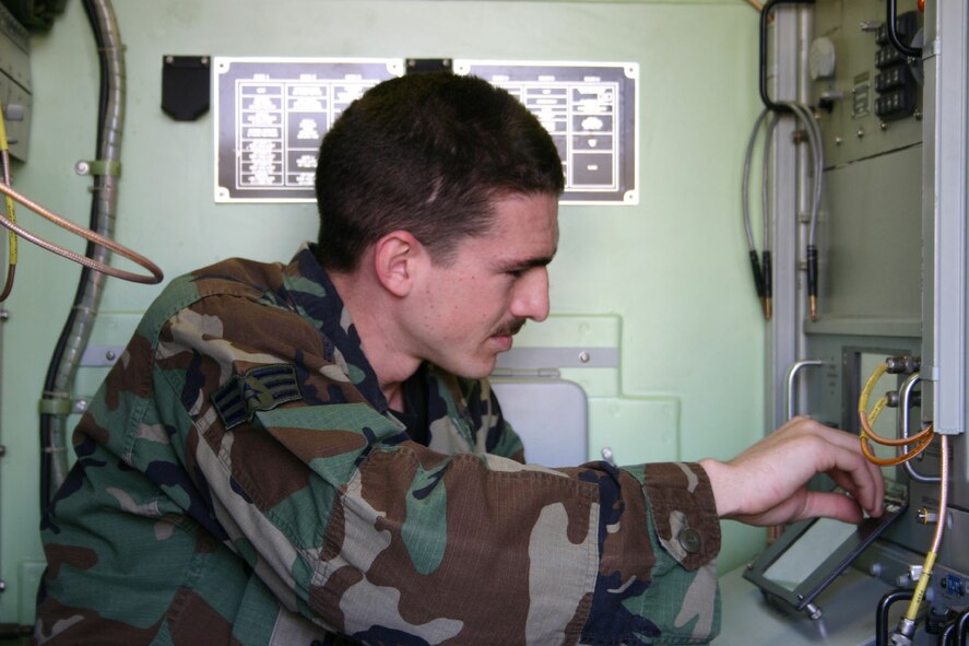 SPANGDAHLEM AIR BASE, GERMANY – Senior Airman Daniel Robinson, 606th Air Control Squadron, configures a signal multiplexer in a satellite communications terminal during a local training exercise which provided wartime task upgrade training to 30 satellite communications personnel assigned to the squadron’s Satellite and Wideband Systems work center. (US Air Force photo/Staff Sgt. Daniel Heise)