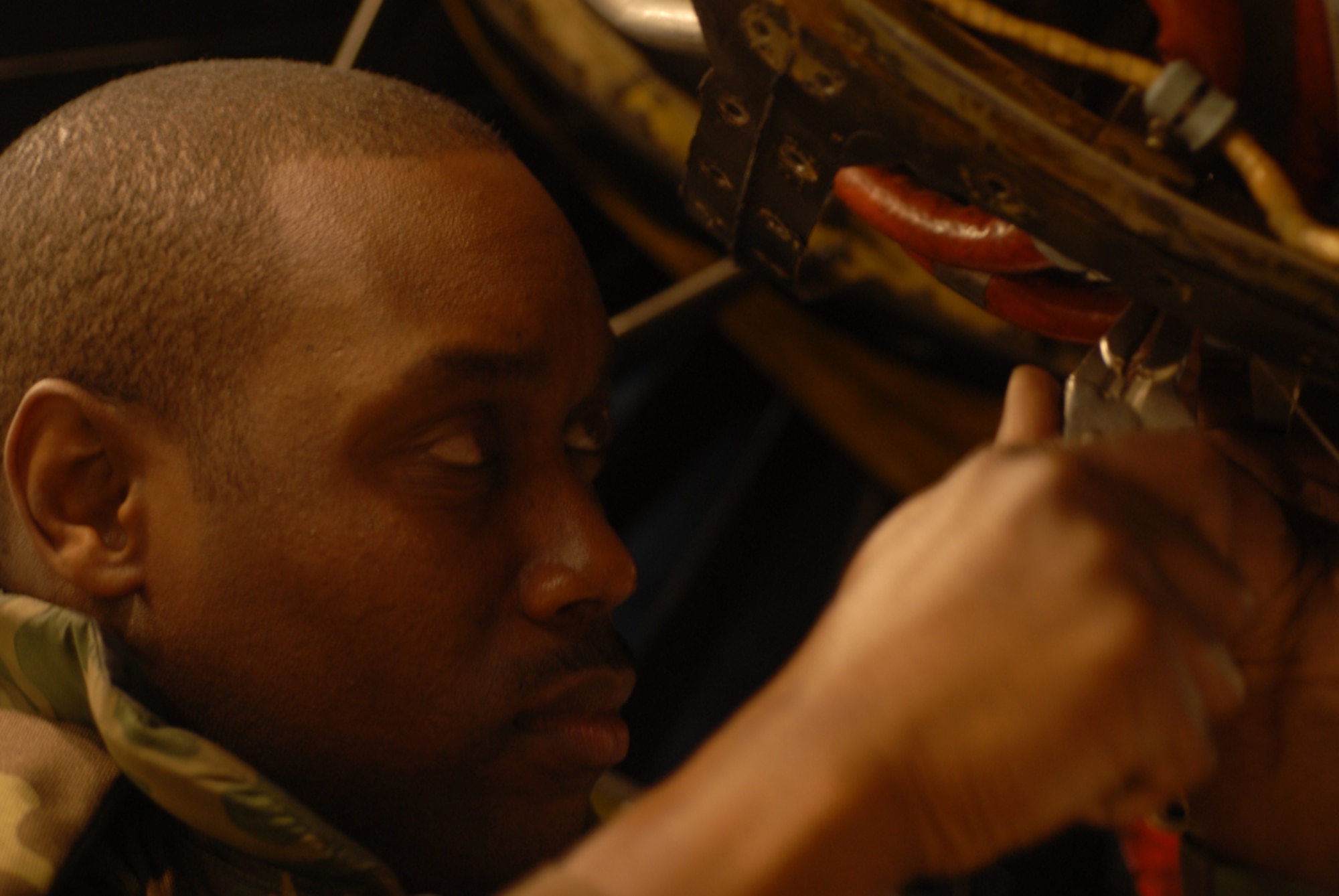 070424-F-9232-014
KADENA AIR BASE, Japan -- Staff Sgt. Jeffrey Williams, 18th Component Maintenance Squadron, wires an engine clamp for an F-15 Eagle on Tuesday.
Kadena Airmen hone their warfighting skills and streamline their deployment capabilities during Exercise Beverly High 07-02.  (U.S. Air Force photograph by Amn Gary M. Edwards Jr.) 