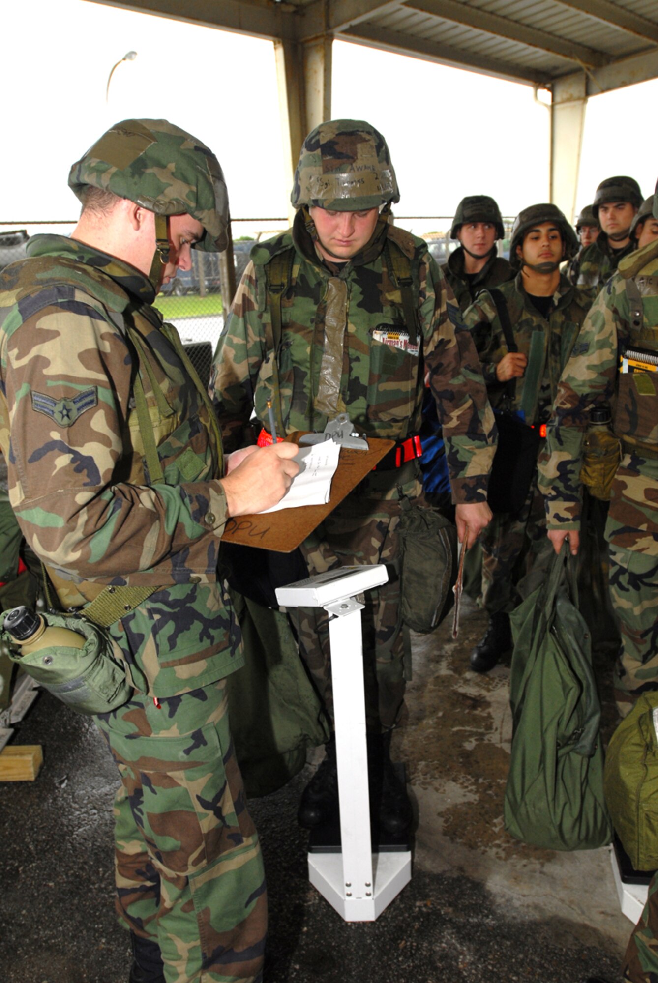 070424-F-3622Z-006
KADENA AIR BASE, Japan -- Airman 1st Class Andrew Brower (left), 18th
Logistics Readiness Squadron, weighs in Airmen Tuesday at the Kadena Installation
Deployment Readiness Center during Exercise Beverly High 07-02 activities.  This portion of the exercise tested the wing's ability to mobilize and process personnel and cargo and simulate deploying them to a forward base.  (U.S. Air Force/Airman 1st Class Kasey Zickmund)