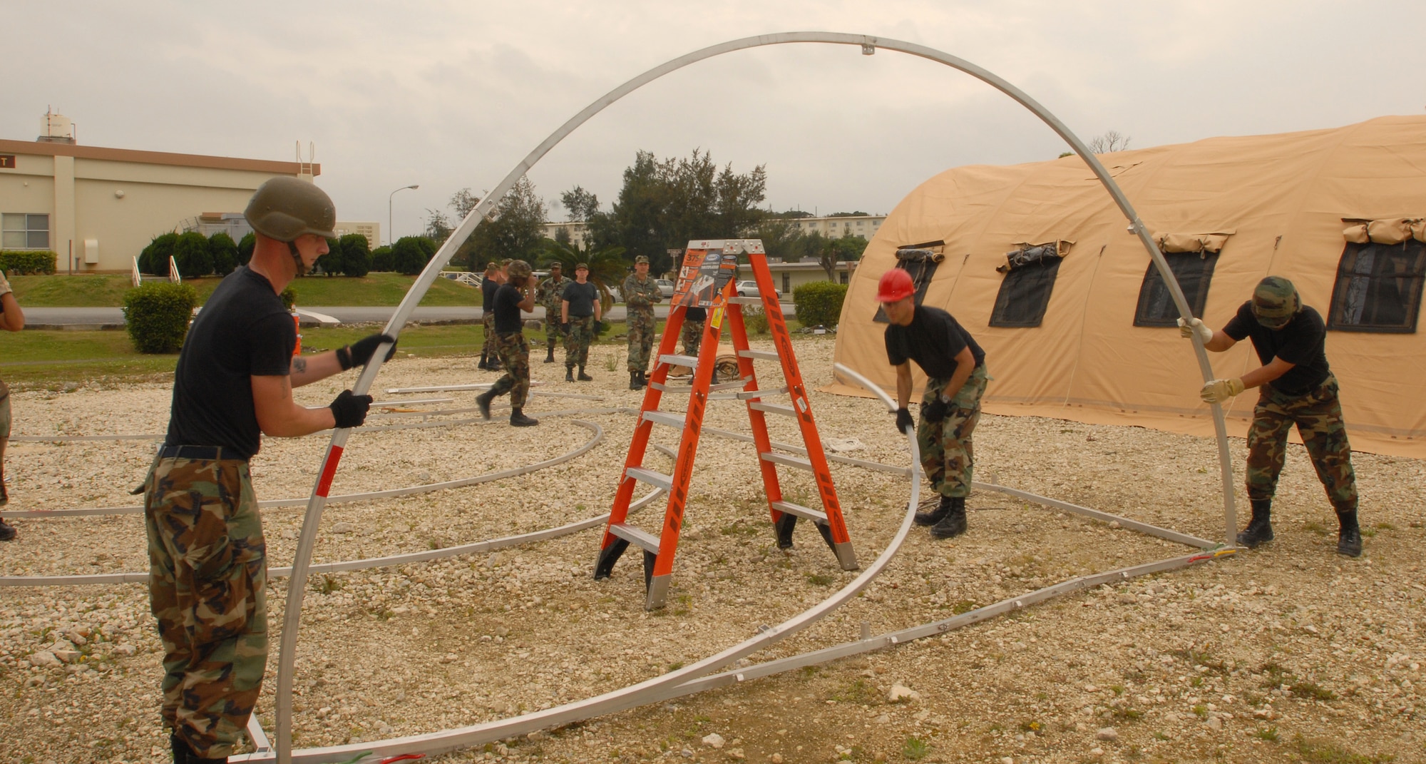 070423-F-3652I-007
KADENA AIR BASE, Japan -- Members of the 18th Civil Engineer Group set up a small Alaskan shelter for their annual overnight bivouac training during Exercise Beverly High 07-02 activities. The bivouac is a bed-down exercise to train civil engineers how to live and work in a deployed environment.  Kadena's 18th Wing held a week-long exercise designed to test the wing's ability to mobilize people and cargo, respond to crises and project combat airpower.  (Air Force/Airman 1st Class Ryan Ivacic)