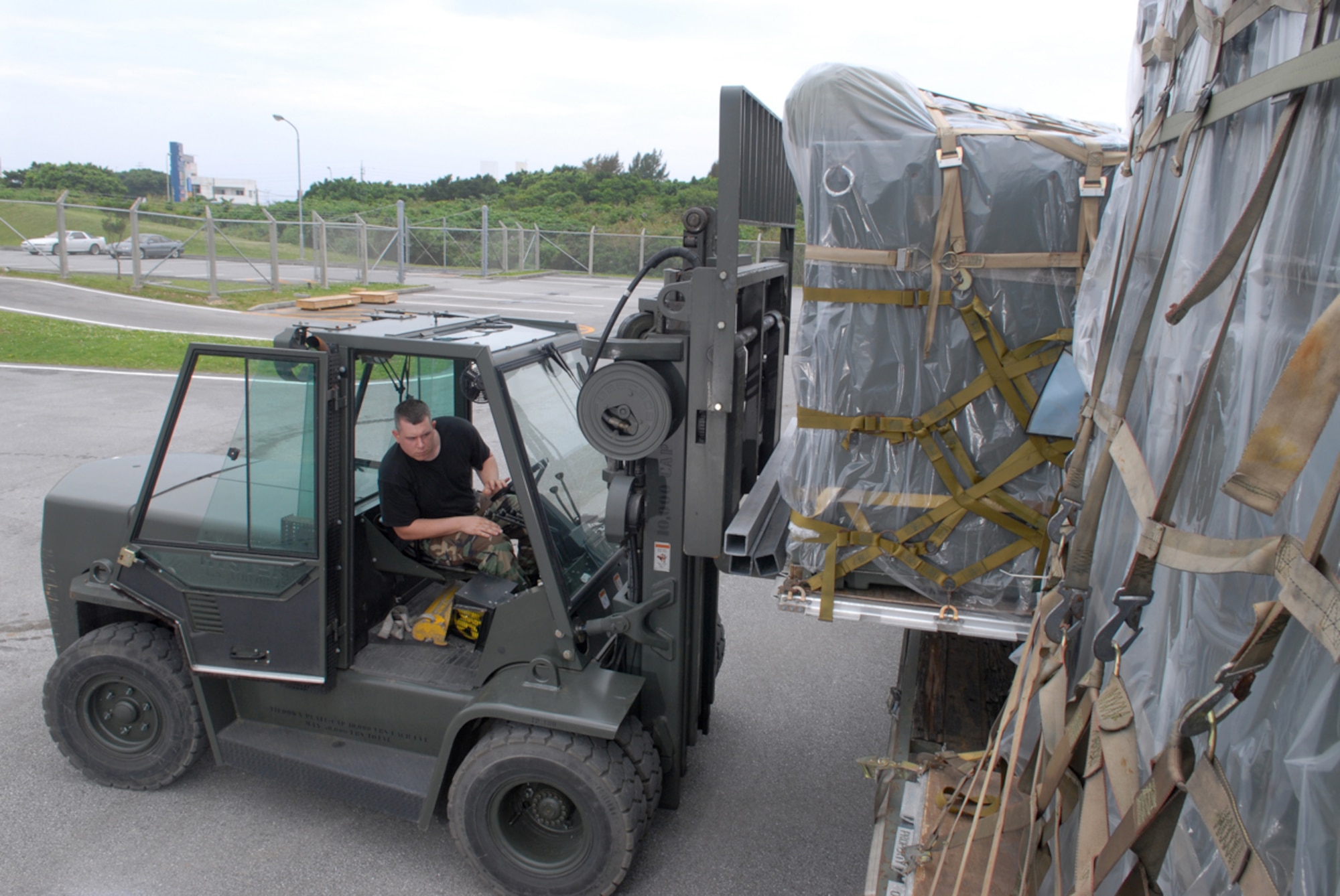 070423-F-0523M-019
KADENA AIR BASE, Japan -- Airman 1st Class Joseph Johnson, 18th Logistics Readiness Squadron, loads supplies from the 18th Communication Squadron to be taken to a processing area for cargo to be deployed during exercise activities here. Kadena's 18th wing held a week-long exercise designed to test the wing's ability to deploy people and cargo to a forward base, respond to crises and project combat airpower. (U.S. Air Force Photo by Senior Airman Jeremy McGuffin)