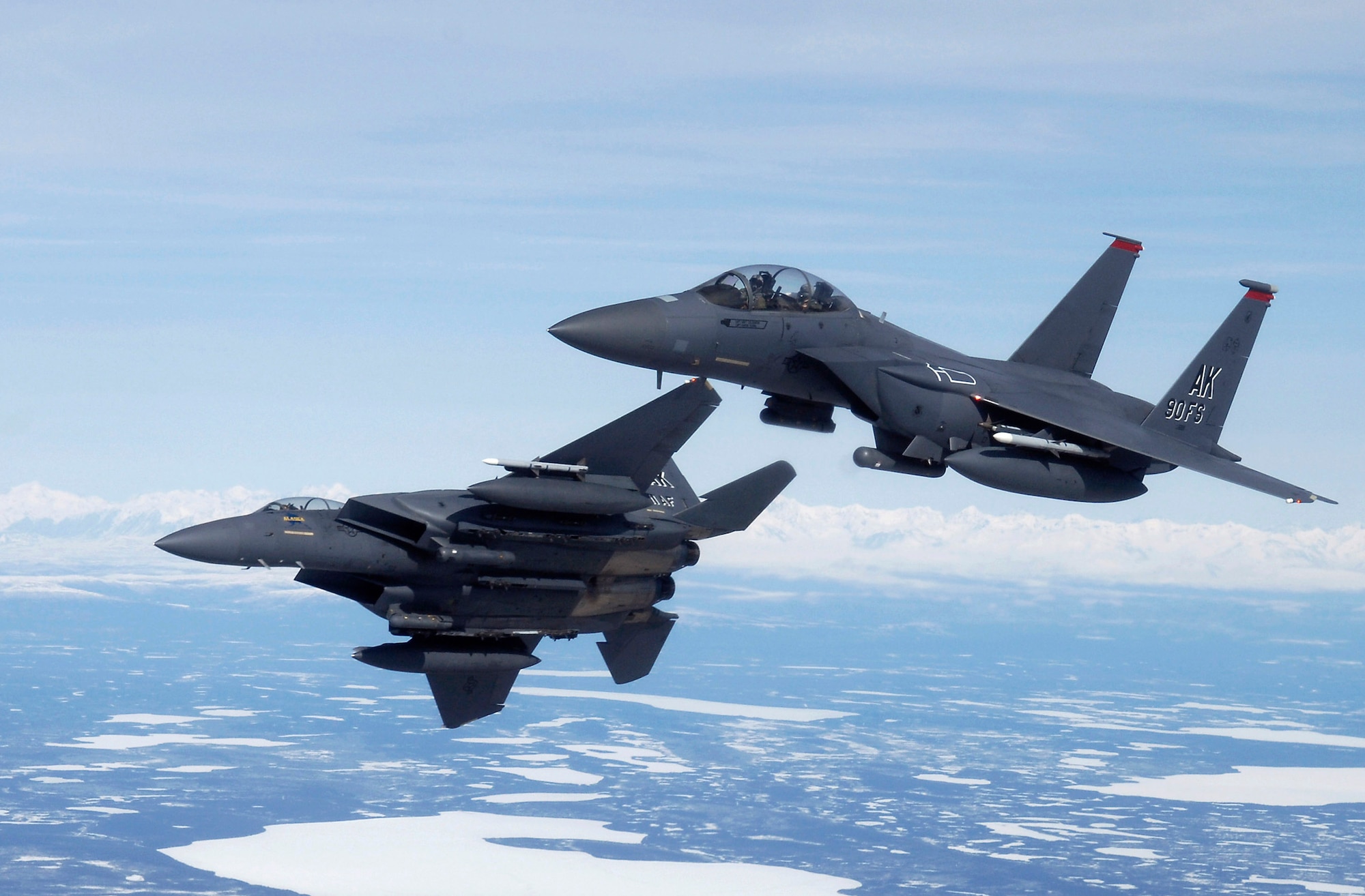 Two F-15E Strike Eagles maneuver to bomb a ground target during a training flight April 20 over Alaska. The F-15Es are assigned to the 90th Fighter Squadron at Elmendorf Air Force Base, Alaska, which traces its history back to August 1917. An array of avionics and electronics systems gives the F-15E the capability to fight at low altitude, day or night, and in all weather. The F-15E at Elmendorf AFB will soon be replaced by the F-22 Raptor. (U.S. Air Force photo/Tech. Sgt. Keith Brown)