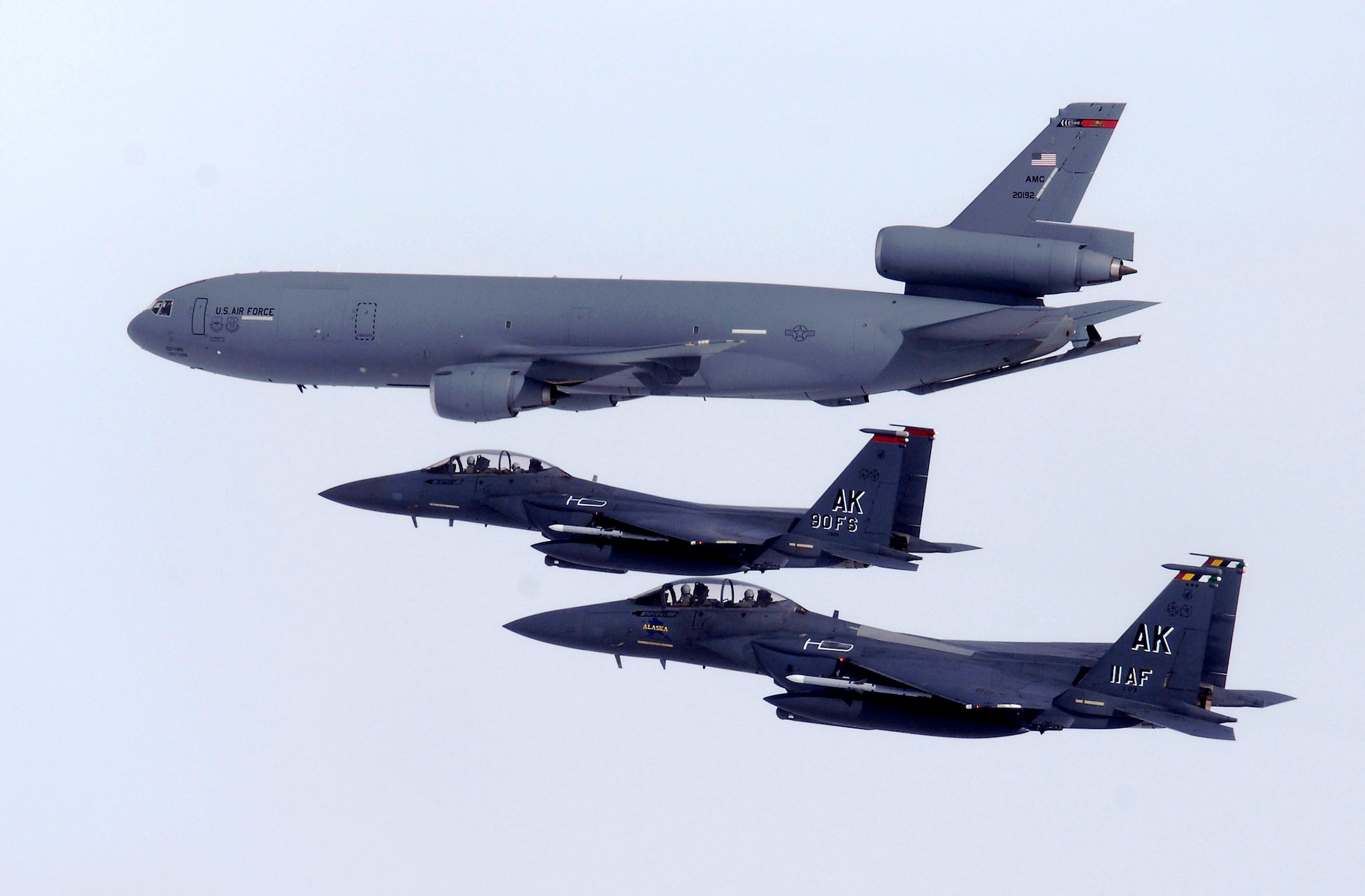 Two F-15E Strike Eagles fly alongside a KC-10 Extender April 20 over Alaska. The F-15E is assigned to the 90th Fighter Squadron at Elmendorf Air Force Base, Alaska, which traces its history back to August 1917. The F-15E at Elmendorf AFB will soon be replaced by the F-22 Raptor. The KC-10 is from Travis Air Force Base, Calif. (U.S. Air Force photo/Tech. Sgt. Keith Brown)
