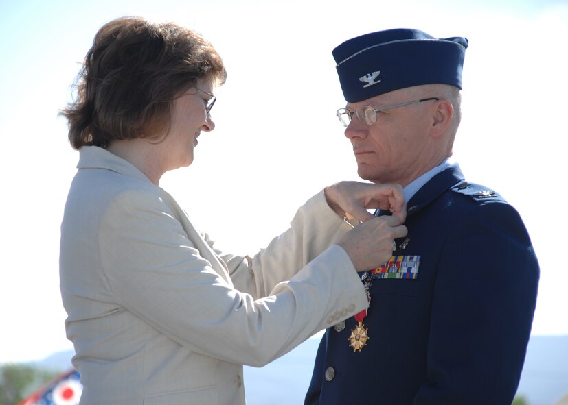 Mrs. Gail Adkins pins the retirement pin onto Col. Matthew Adkins, 49th Medical Group commander, at his retirement ceremony April 23 at Holloman Air Force Base after nearly 30 years of military service. (U.S. Air Force photo by Airman 1st Class Jamal Sutter)
