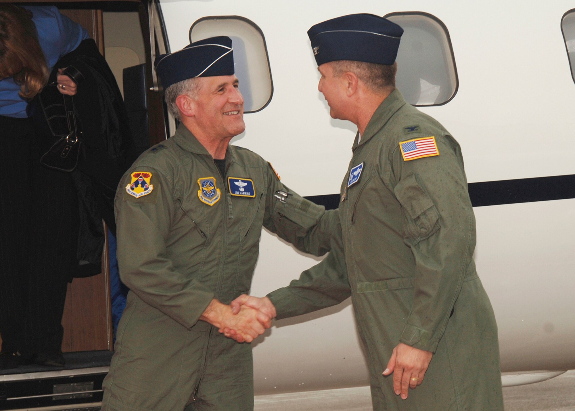 Col. Donald J. Halpin, right, 22nd Air Refueling Wing commander, greets Maj. Gen. James A. Hawkins, 18th Air Force commander, as he arrives at McConnell April 24. General Hawkins, along with his wife, Linda, and Chief Master Sgt. Brye McMillon, 18th Air Force command chief master sergeant, visited McConnell from Scott Air Force Base, Ill., April 24 to 26. (Photo by Airman 1st Class Jessica Corob)