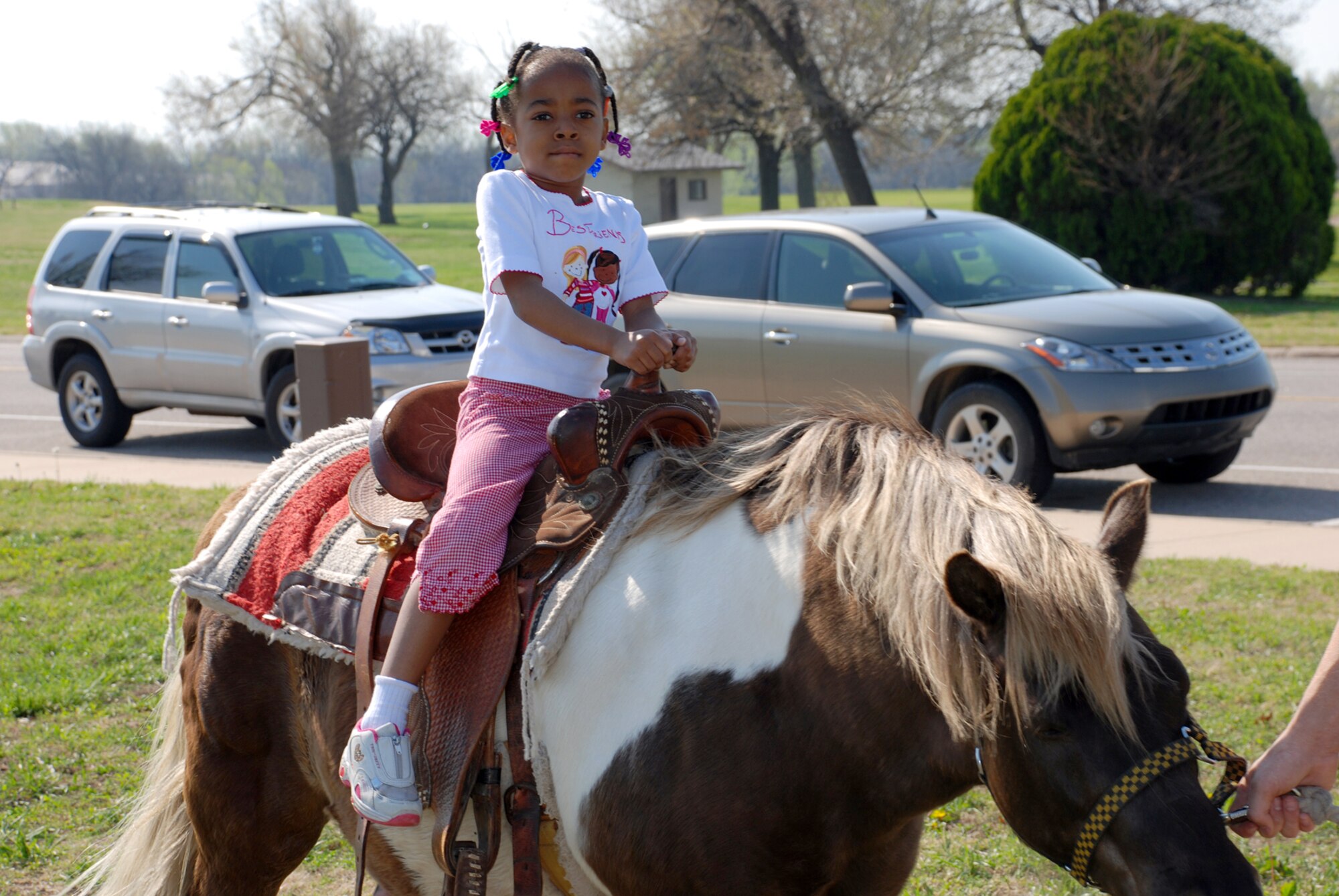 Morgan Campbell enjoys a pony ride at the ninth annual Family Festival of Fun April 21 at the Robert J. Dole Center here. (Photo by Airman 1st Class Jessica Lockoski)