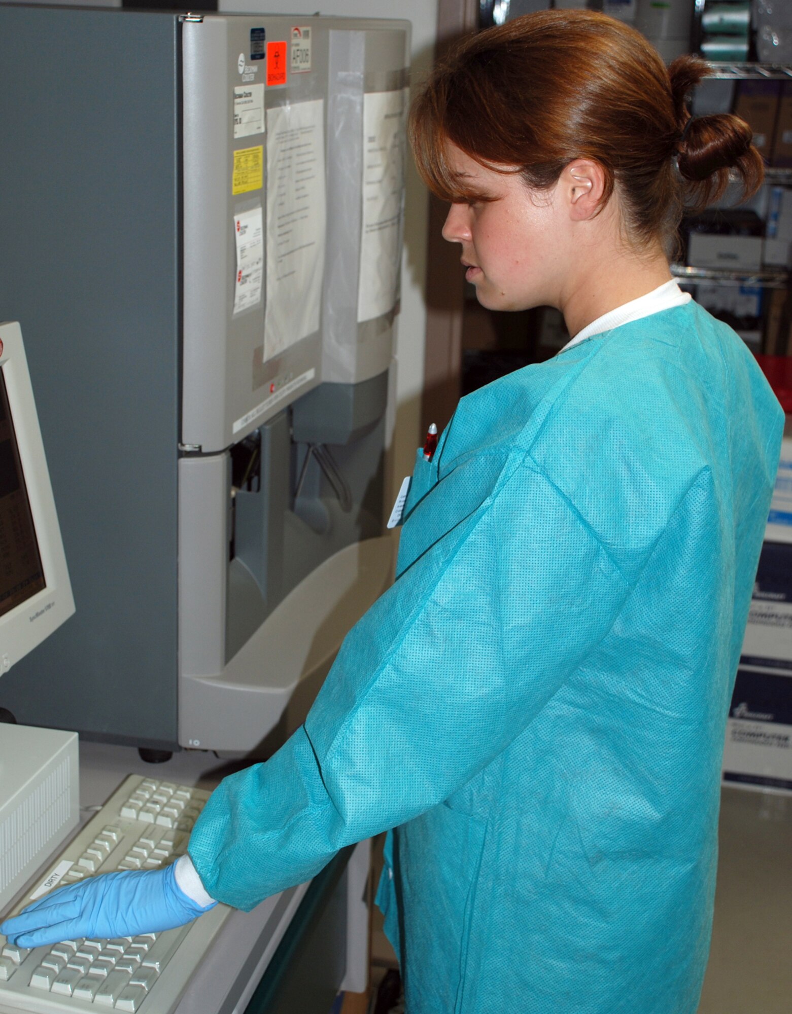 Airman 1st Class Kyle Mills, a 22nd Medical Support Squadron lab technician, initiates the primary mode of testing samples on the Coulter hematology machine. The machine runs tests such as complete blood cell counts and hemoglobin/hematocrit levels. (Photo by Airman 1st Class Jessica Lockoski)