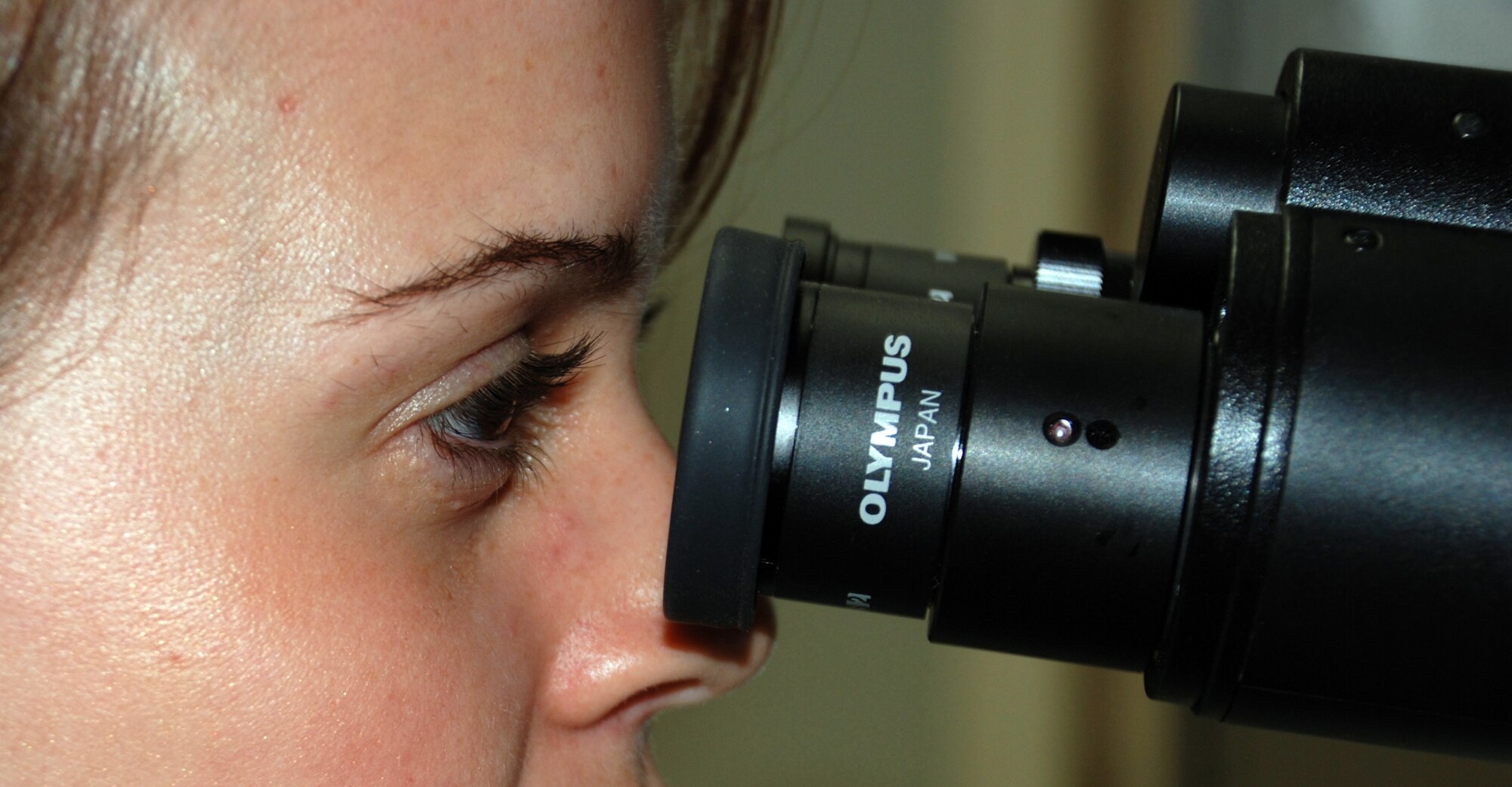 Airman 1st Class Kyle Mills, a 22nd Medical Support Squadron lab technician, looks at a patient's blood sample through a microscope April 24 at the laboratory here. She examines the sample to get a blood-cell count and to check it for any conditions or disorders that might affect the patient. (Photo by Airman 1st Class Jessica Lockoski)