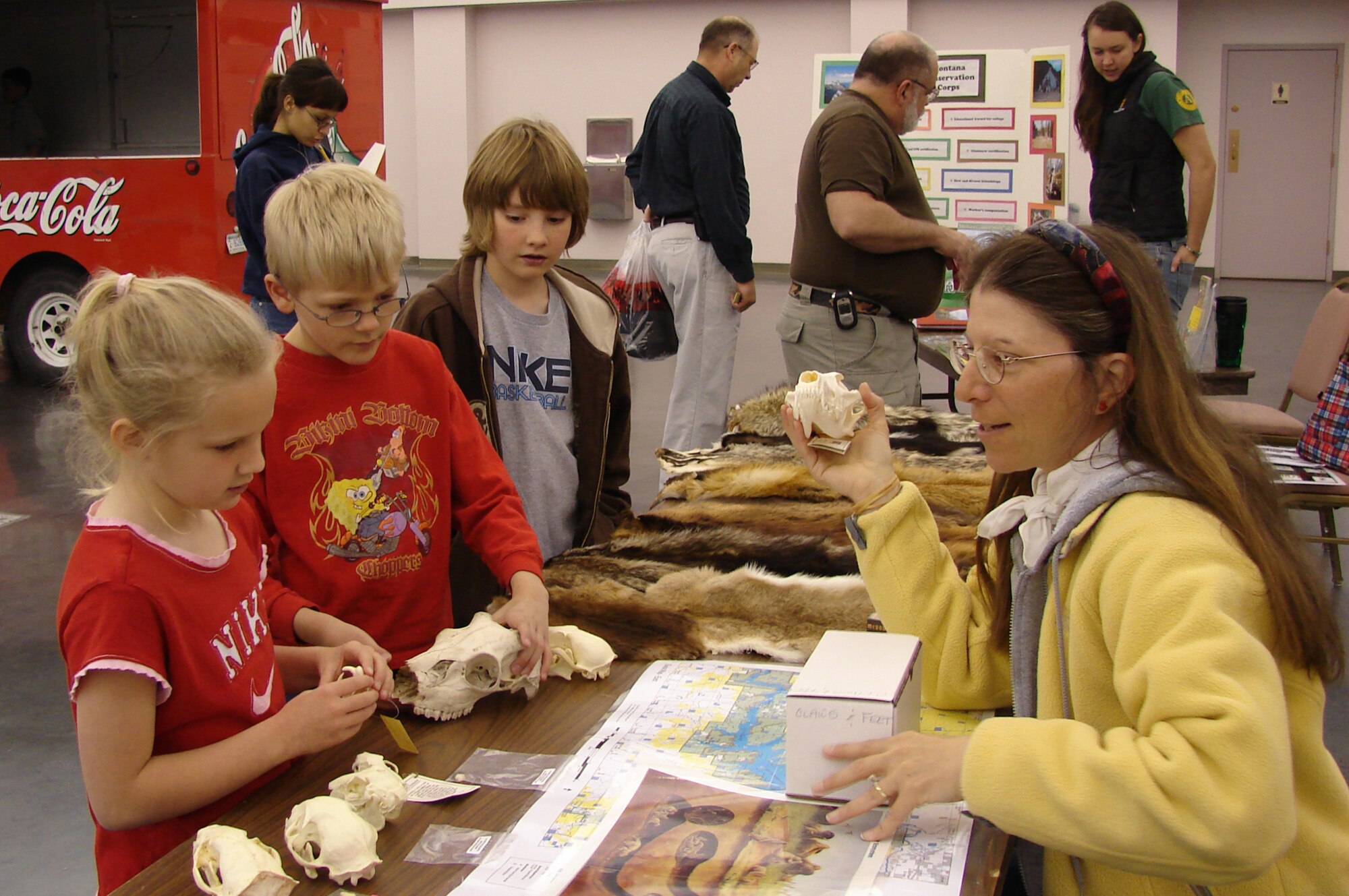 Joyce Levy of the Charles M. Russell National Wildlife Foundation from Fort Peck, Mont., explains to Little Warriors Madison, 7, Ryan, 8, and Trent, 10, why certain wildlife species in Montana are becoming endangered. Ms. Levy had an informational booth at the Earth Day festivities at the Great Falls Civic Center April 22.