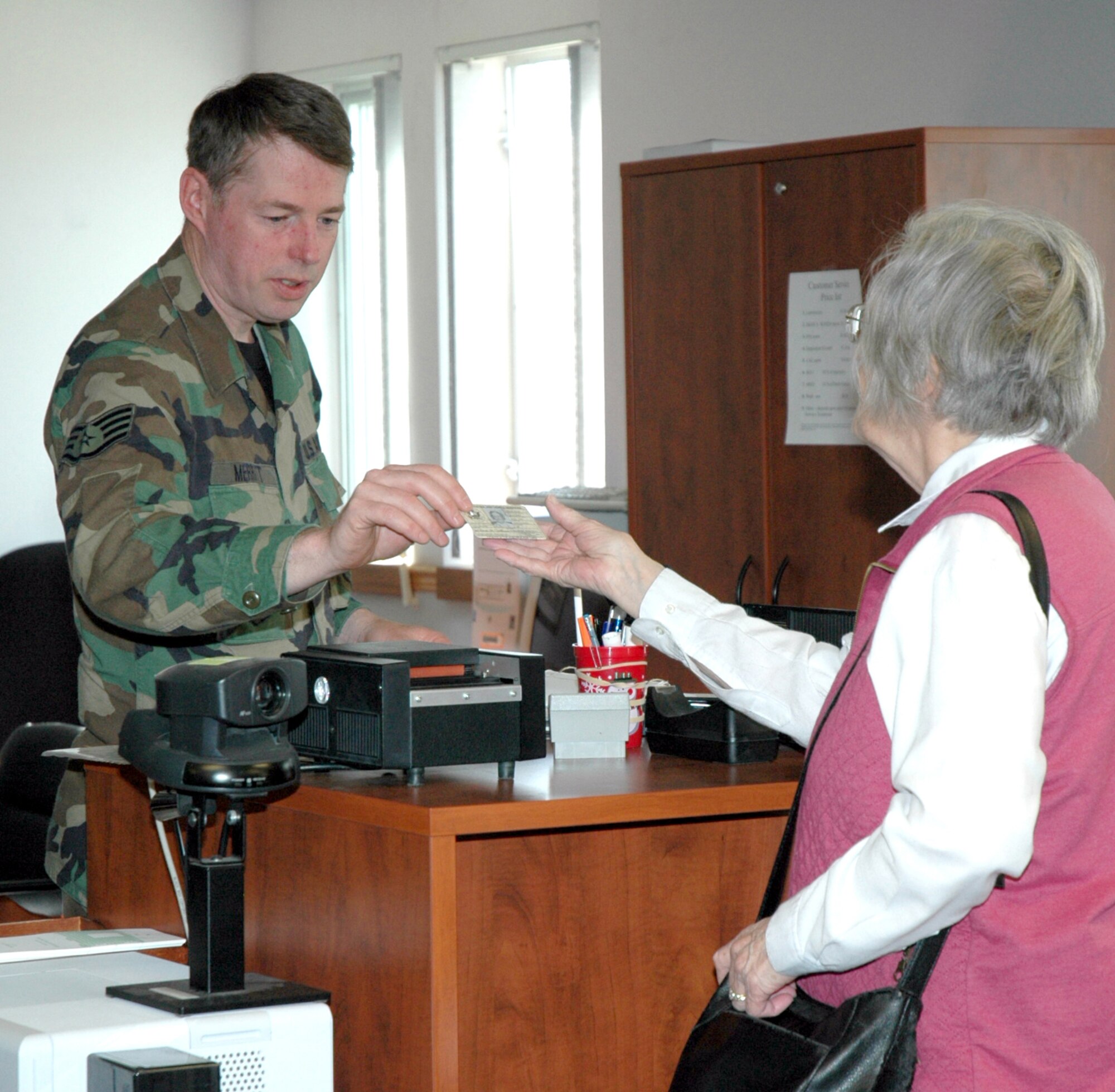A retired family member receives her new ID card.
