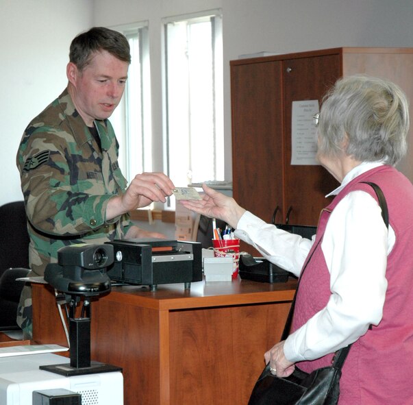 A retired family member receives her new ID card.