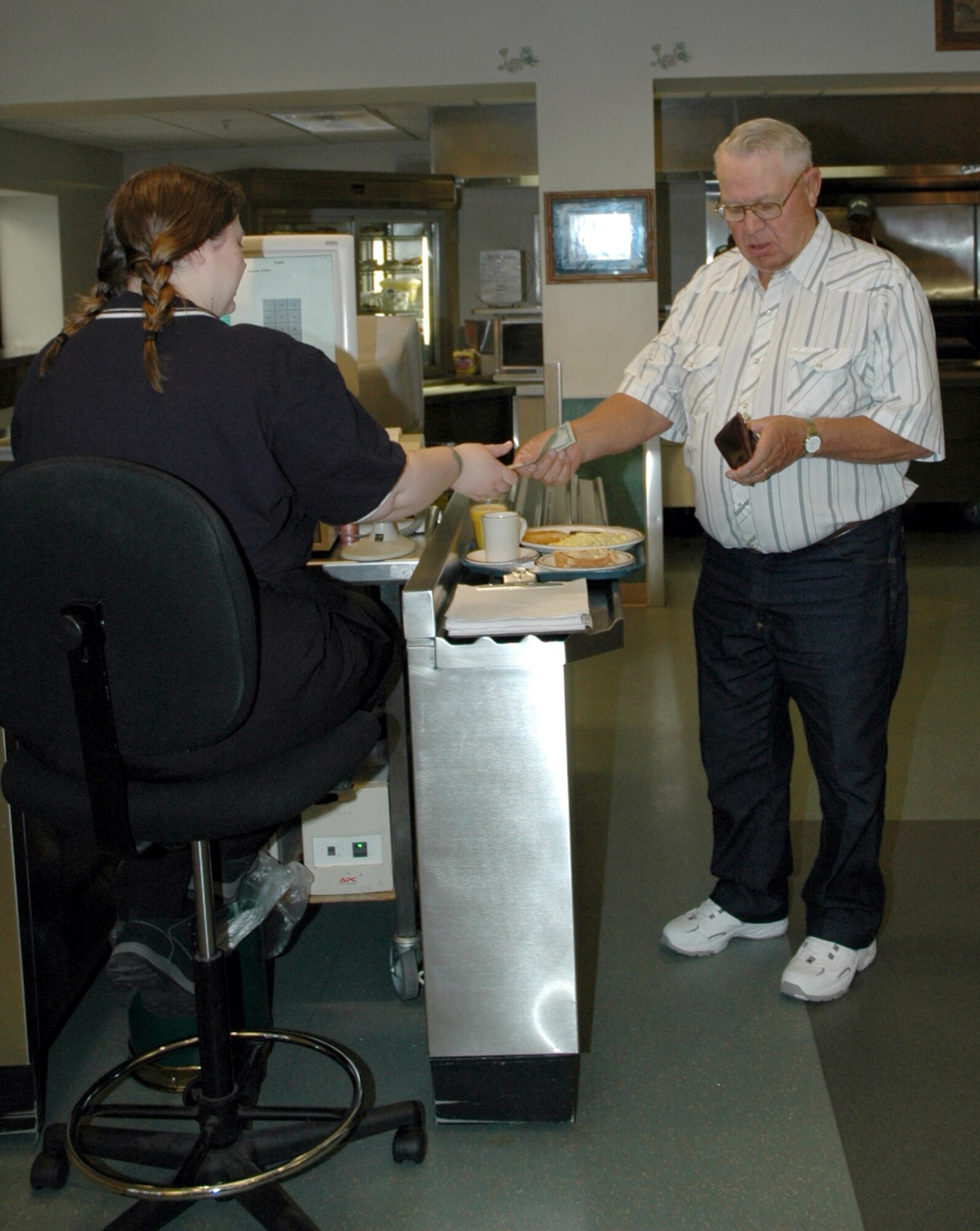 A retiree pays for breakfast at the Elkhorn Diner during last year’s Retiree Weekend celebration. 