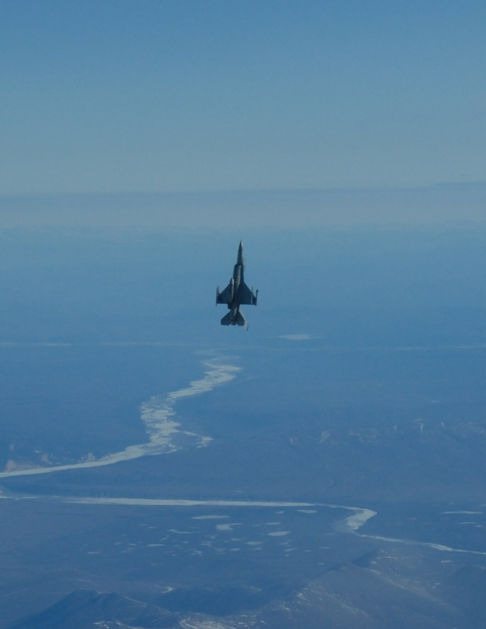 EIELSON AIR FORCE BASE, Alaska--Captain Aaron Brown, F-16 Fighting Falcon pilot from the18th Fighter Squadron, performs a max climb over the Pacific Alaska Range Complex.  The 18th Fighter Squadron conducts air operations for combat-ready F-16 aircraft, working closely with 355th Fighter Squadron to provide close air support, forward air control (airborne), battlefield air interdiction, and offensive counter air. (U.S. Air Force photo by Master Sgt. Robert Wieland) 