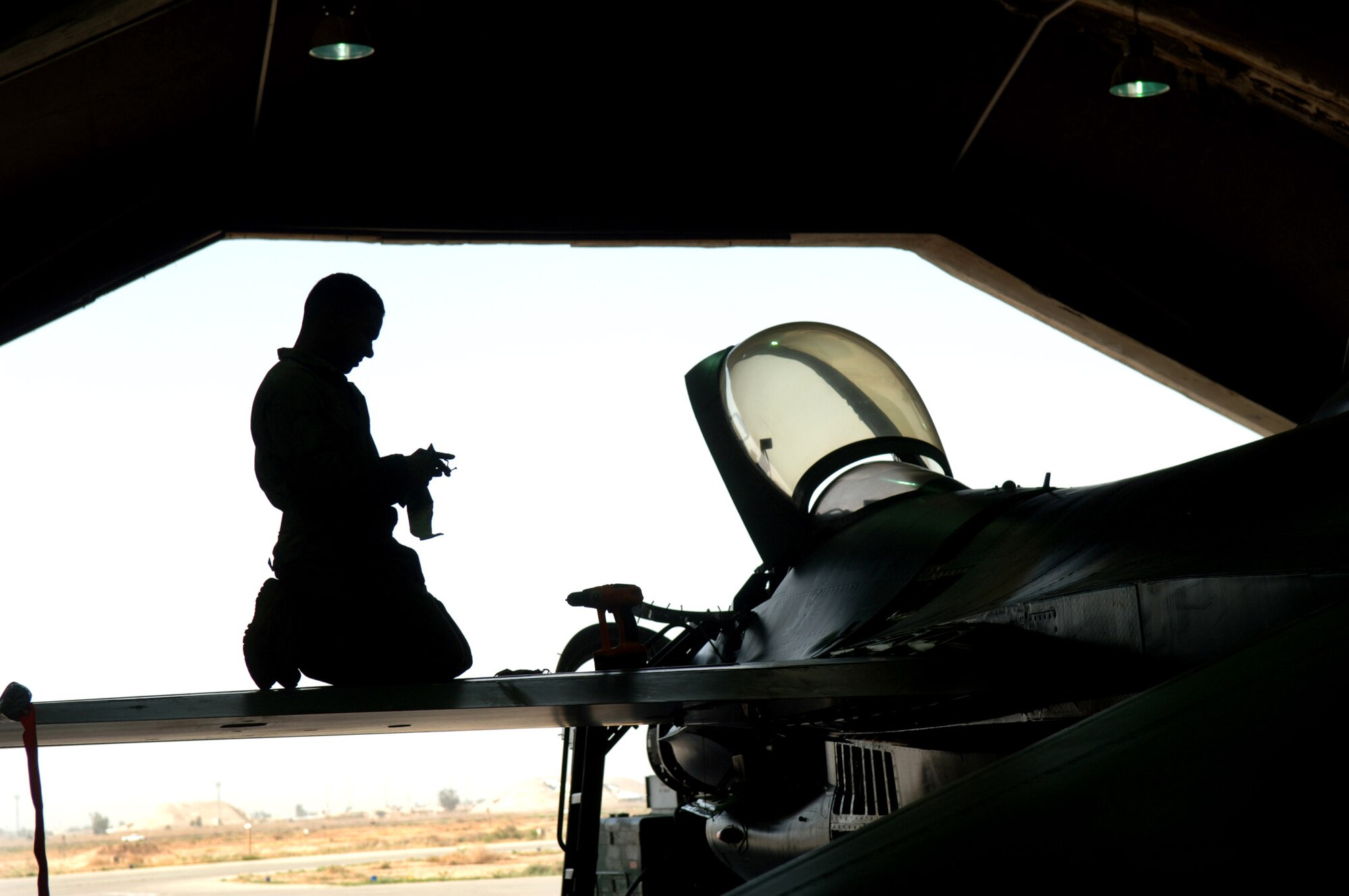 Senior Airman Gil Alicea performs a phase dock inspection on an F-16 Fighting Falcon April 16 at Balad Air Base, Iraq.  Maintainers run the inspection every 400 flying hours to keep the aircraft mission-ready. Airman Alicea is with the 332nd Expeditionary Maintenance Squadron. (U.S. Air Force photo/Airman 1st Class Nathan Doza)