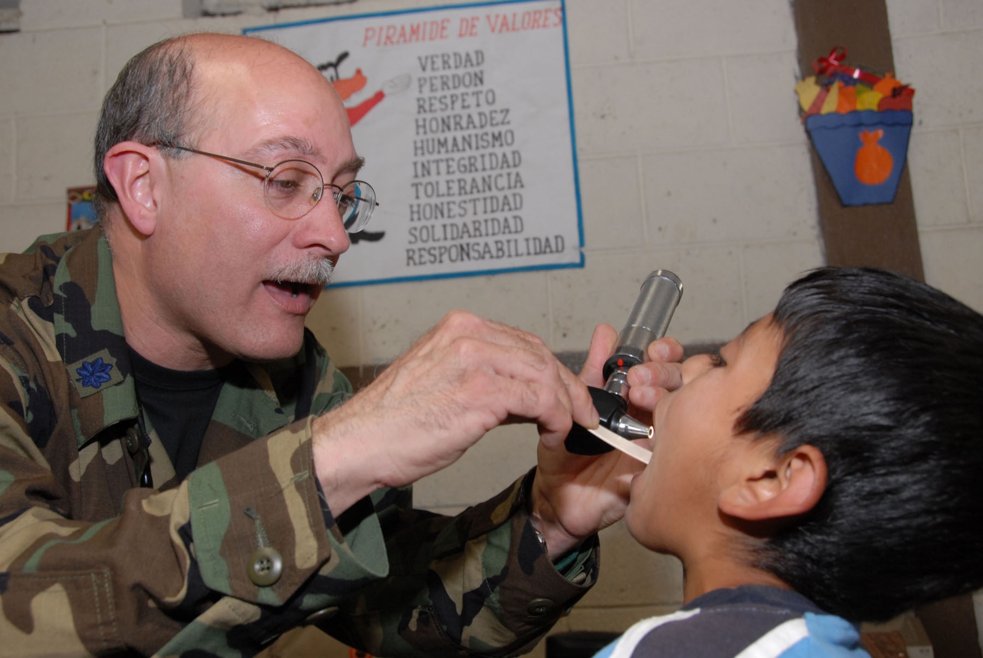 Lt. Col. (Dr.) Roberto Caro, a flight surgeon with the Air Force Reserve Command's 445th Aerospace Medicine Squadron, Wright Patterson Air Force Base, Ohio, performs a medical examination on a young Guatemalan boy during the New Horizons Medical Readiness Training Exercise conducted in the San Marcos region April 14-28, 2007. General medicine treated more than 5,800 patients during the two-week mission. (Air Force photo/Master Sgt.Chance C. Babin)