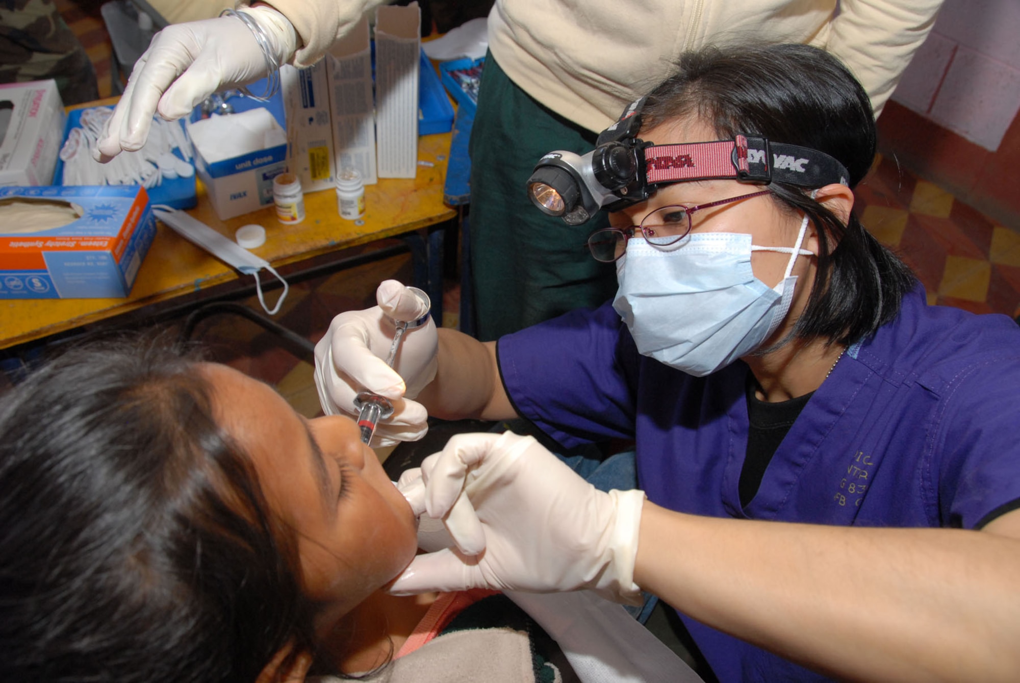 Maj. (Dr.) Joan Salido, a dentist with the Air Force Reserve Command's 445th Aerospace Medicine Squadron, Wright Patterson Air Force Base, Ohio, administers anesthisia to a Guatemalan patient during the New Horizons Medical Readiness Training Exercise conducted in the San Marcos region April 14-28, 2007. (Air Force photo/Master Sgt. Chance C. Babin)