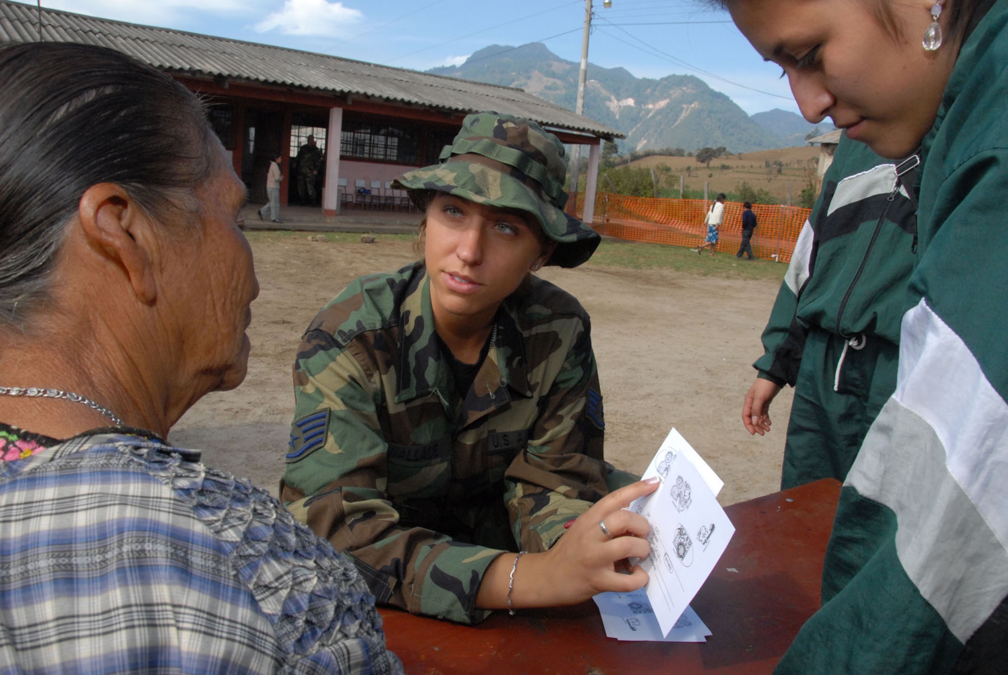 Staff Sgt. Lisa Wallace, a medical technician with the Air Force Reserve Command's 445th Aerospace Medicine Squadron, Wright Patterson Air Force Base, Ohio, with the help of student interpreter triages a patient to receive medical care during New Horizons Medical Readiness Training Exercise conducted near San Marcos, Guatemala, April 14-28, 2007. The medical team treated more than 8,000 patients during their stay in Guatemala. (Air Force photo/Master Sgt. Chance C. Babin)