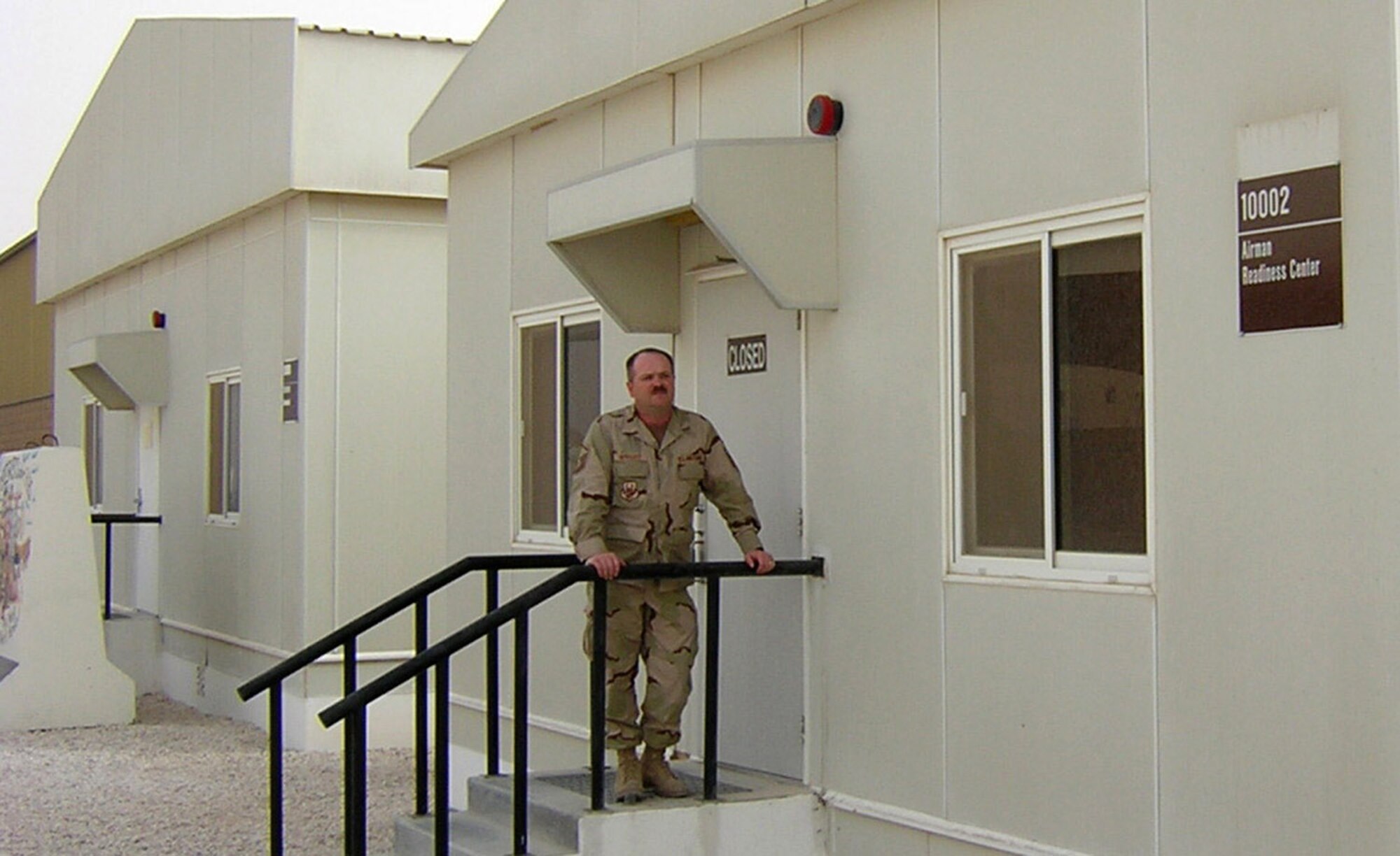 Master Sgt. Steven Wright stands outside the Air Force's first deployed Airman Readiness Center in Southwest Asia. The sergeant recently deployed from Mountain Home Air Force Base, Idaho, to establish the readiness center to help servicemembers stationed in the region. (U.S. Air Force photo)