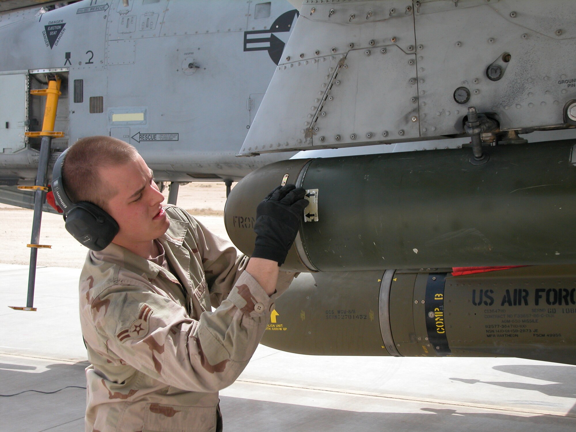 AL ASAD AIR BASE, Iraq — Airman 1st Class Cory Bridges, a weapons loader with the 438th Expeditionary Aircraft Maintenance Squadron, removes a nose fairing from a LAU-131 rocket pod prior to an A-10 Thunderbolt II combat mission here. The 438th EAMXS belongs to the 438th AEG which activated here Jan. 15, 2007, to provide close air support for Coalition Forces in the region. Within hours of standing up as a fully operational combat flying unit, the group was launching its fierce 'Warthogs' into battle. The A-10's distinctive nose art has been known to strike fear into enemy combatants unlucky enough to see its hungry, shark-toothed facade grinning at them. (U.S. Air Force photo/Master Sgt. Bryan Ripple)