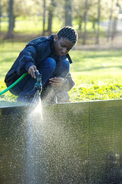A volunteer cleans the Vietnam Veterans Memorial April 21 in Washington, D.C.  Members of the Air Force Sergeants Association, with volunteers from Charleston, Shaw, Pope, Seymour Johnson, Langley and Bolling Air Force Bases, were among those who participated in the event. (U.S. Air Force photo/Tech. Sgt. Cohen A. Young) 
