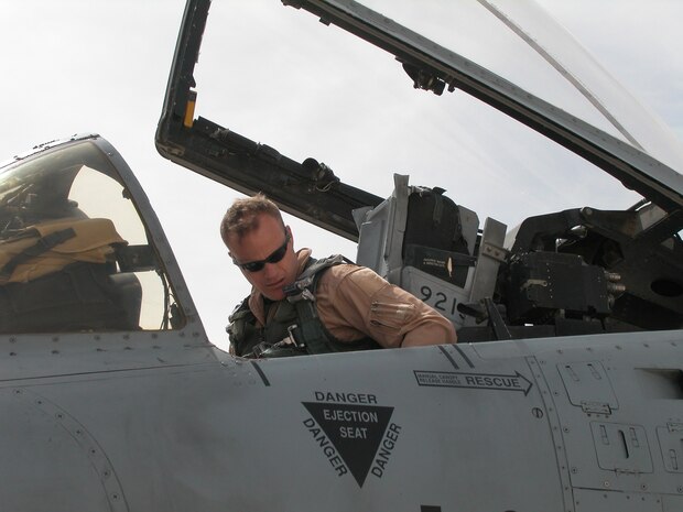 AL ASAD AIR BASE, Iraq -- Maj. Robert "Notch" MacGregor, assistant director of operations for the 74th Expeditionary Fighter Squadron, straps in for a combat mission over Al Anbar Province in western Iraq. The 74th EFS is part of the 438th Air Expeditionary Group, which is assigned to the 332nd Air Expeditionary Wing, the only Air Force wing in Iraq. The group activated Jan. 15, 2007, to provide close air support for Coalition Forces in the region. Within hours of standing up as a fully operational combat flying unit, the group was launching its fierce 'Warthogs' into battle. The A-10's distinctive nose art has been known to strike fear into enemy combatants unlucky enough to see its hungry, shark-toothed facade grinning at them. (U.S. Air Force photo/Master Sgt. Bryan Ripple)