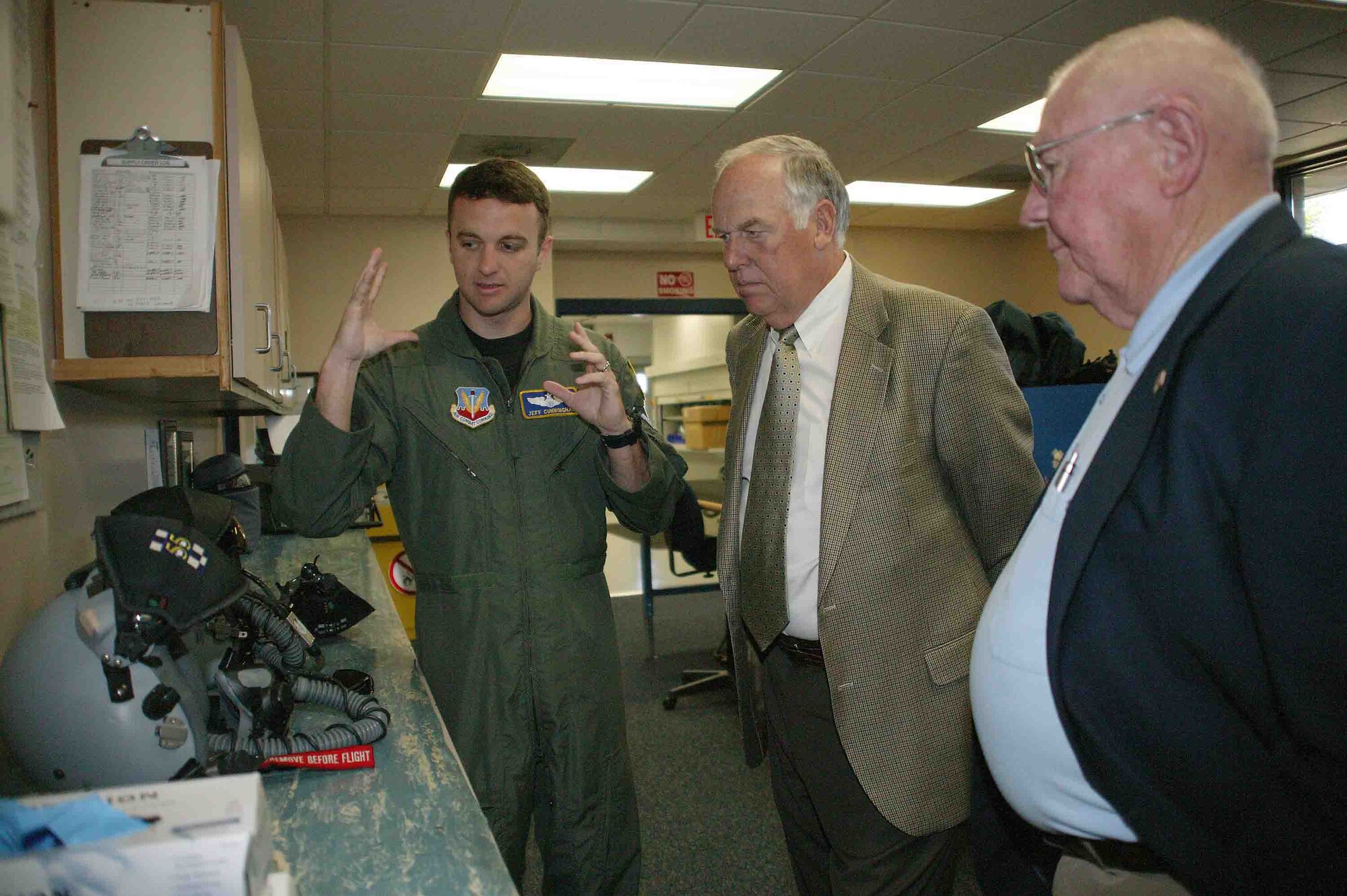 SHAW AIR FORCE BASE, S.C. -- Maj. Jeff Cunningham (left), 55th Fighter Squadron F-16CJ fighter pilot, discusses the technology of a fighter pilot's helmet to John Peebles (center), 20th Fighter Wing Association president, and Robert Scofner, local representative of the 20th FW Association, April 23. During their visit, Mr. Peebles and Mr. Scofner met with wing leaders and toured the 55th Fighter Squadron. The 20th FW Association is composed of former members of the wing, its subordinate organizations and its predecessors to promote the history of the unit. The 20th FW traces its lineage to the 20th Pursuit Group which was later absorbed by the 20th Fighter Bomber Wing. The 20th was one of the 13 original combat air groups formed by the Army before World War II.  (U.S. Air Force photo/Senior Airman John Gordinier)