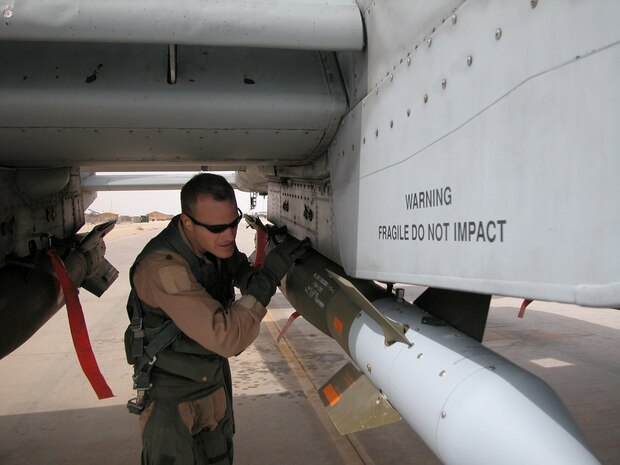 AL ASAD AIR BASE, Iraq — Maj. Robert "Notch" MacGregor, assistant director of operations for the 74th Expeditionary Fighter Squadron, goes over a preflight check of his aircraft as he prepares for a combat mission over Al Anbar Province in western Iraq. Major MacGregor is an A-10 Thunderbolt II pilot with the 74th EFS, 438th Air Expeditionary Group, which is assigned to the 332nd Air Expeditionary Wing, the only Air Force wing in Iraq. The group activated Jan. 15, 2007, to provide close air support for Coalition Forces in the region. Within hours of standing up as a fully operational combat flying unit, the group was launching its fierce 'Warthogs' into battle. The A-10's distinctive nose art has been known to strike fear into enemy combatants unlucky enough to see its hungry, shark-toothed facade grinning at them. (U.S. Air Force photo/Master Sgt. Bryan Ripple)