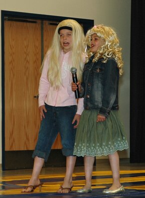 FAIRCHILD AIR FORCE BASE, Wash. – Joseph Mikolajczyk, 8, son of Master Sgt. Paul Mikolajczyk, 336th Training Group, and Jacob Humble, 9, son of Gina Humble, 92nd Services Squadron commander, sing Barbie Girl during a talent show at a carnival at Michael Anderson Elementary School April 21. More than 500 people attended the carnival, which was held to raise money for the school’s Parent Teacher Organization.. (U.S. Air Force photo/Staff Sgt. Kristian Carter)
