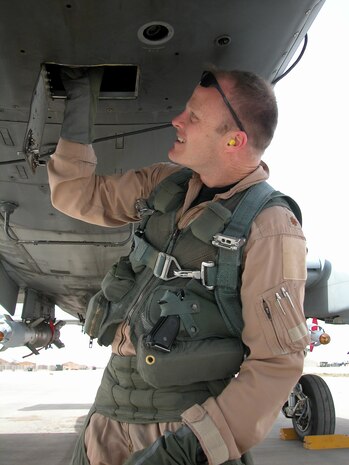 AL ASAD AIR BASE, Iraq -- Maj. Robert "Notch" MacGregor, assistant director of operations for the 74th Expeditionary Fighter Squadron, goes over a pre-flight check of his aircraft as he prepares for a combat mission over Al Anbar Province in western Iraq. Major MacGregor is an A-10 Thunderbolt II pilot with the 74th EFS, 438th Air Expeditionary Group, which is assigned to the 332nd Air Expeditionary Wing, the only Air Force wing in Iraq. The group activated Jan. 15, 2007, to provide close air support for Coalition Forces in the region. Within hours of standing up as a fully operational combat flying unit, the group was launching its fierce 'Warthogs' into battle. The A-10's distinctive nose art has been known to strike fear into enemy combatants unlucky enough to see its hungry, shark-toothed facade grinning at them. (U.S. Air Force photo/Master Sgt. Bryan Ripple)
