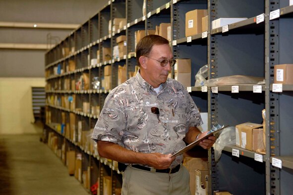 Thomas Smith, 96th Logistic Readiness Squadron's supervisor of the Aircraft Parts Store, inspects inventory.  Mr. Smith was recently recognized at the Air Force level for excellence. (Photo by Bruce Hoffman)