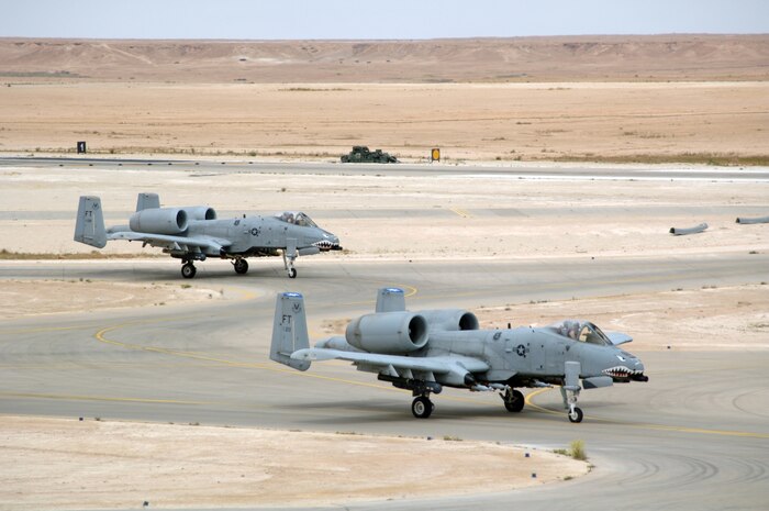 AL ASAD AIR BASE, Iraq — 1st Lt. Chris "Harpoon" Laird (in A-10 on the left) and Maj. Robert "Notch" MacGregor taxi out for takeoff on a combat mission over Al Anbar Province in western Iraq. The A-10 pilots belong to the 438th Air Expeditionary Group activated here Jan. 15, 2007, to provide close air support for Coalition Forces in the region. Within hours of standing up as a fully operational combat flying unit, the group was launching its fierce 'Warthogs' into battle. Since activating, the group has flown some 2,648 flying hours on 820 combat sorties providing CAS in some of the most challenging urban terrain in Iraq including Fallujah, Ramadi, Baghdad and Baquba, overcoming communications jams inherent in operations there, and remaining focused, vigilant and effective against a determined enemy. (U.S. Air Force photo/Capt. Ken Hall)