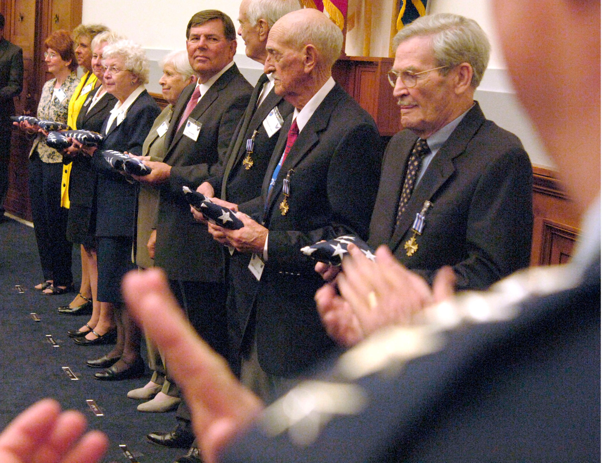 World War II's "Flak Man" B-24 Liberator crewmembers were honored with the Distinguished Flying Cross during a ceremony April 24 in Washington, D.C. From right are crew members 1st Lt. Edward L. "Mac" McNally, Tech. Sgt. Jay T. Fish, Staff Sgt. Robert D. Speed and families of deceased members. (U.S. Air Force photo/Tech. Sgt. Cohen A. Young) 