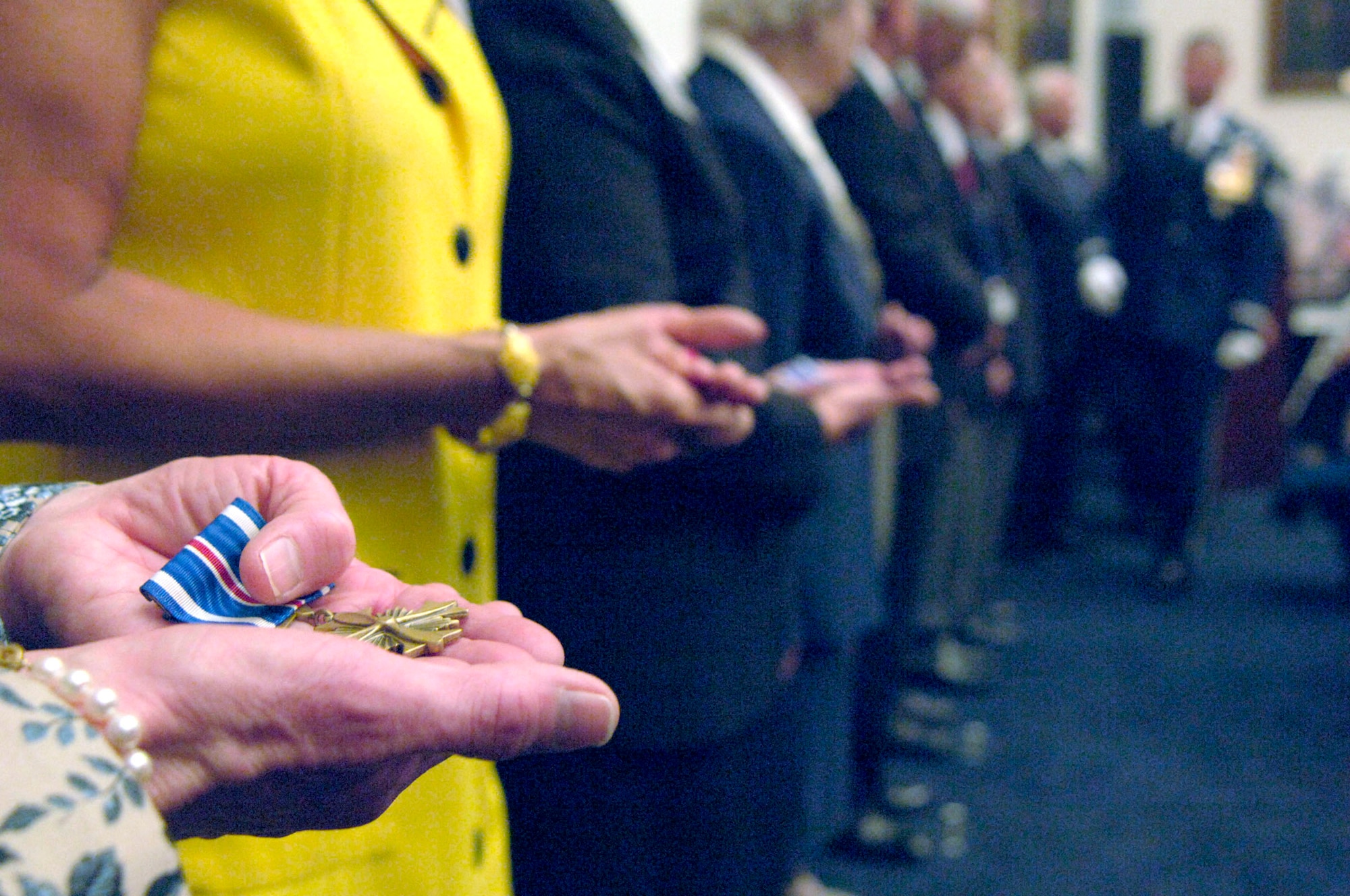 In the hands of surviving members of the "Flak Man" B-24 Liberator crew and the relatives of deceased members is the Distinguished Flying Cross awarded April 24 in Washington, D.C., 63 years after a daring mission in Ploesti, Italy. July 15, 1944, the bomber crew encountered heavy anti-aircraft fire and as a result lost one engine. They still managed to complete their mission of bombing the Nazi's oil refinery lifeline in Romania. They were shot down the next day while participating in a raid over Austria and were taken prisoners of war. (U.S. Air Force photo/Tech. Sgt. Cohen A. Young)