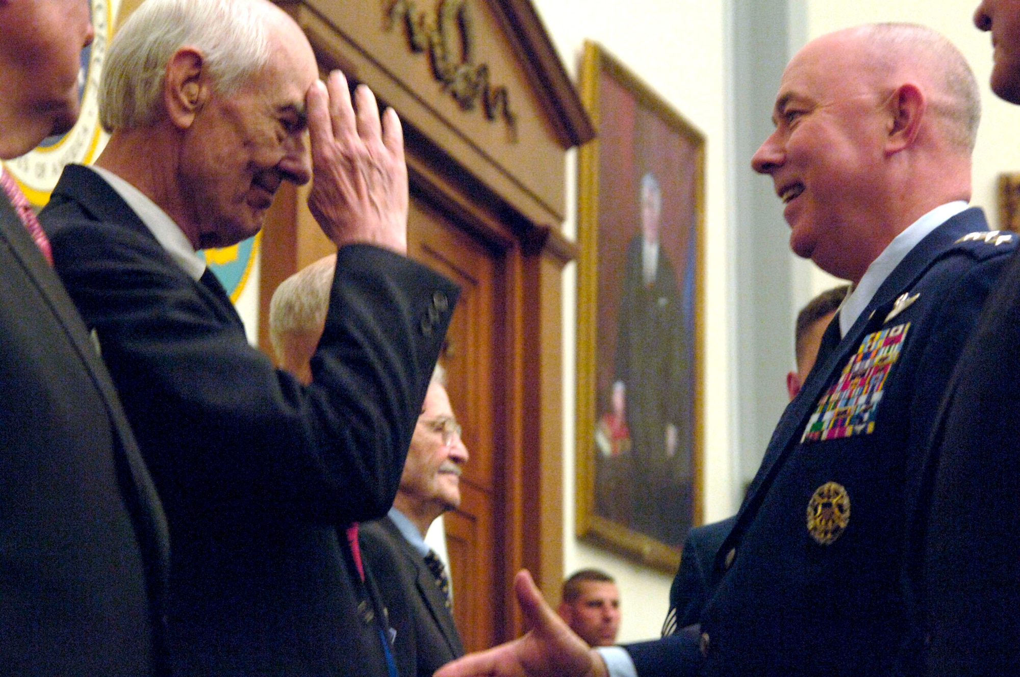 Former Staff Sgt. Robert D. Speed salutes Air Force Chief of Staff Gen. T. Michael Moseley after receiving the Distinguished Flying Cross for his role in the Ploesti, Italy, mission 63 years ago. Mr. Speed was a member of a B-24 Liberator Bomber crew who encountered heavy anti-aircraft fire July 15, 1944, and as a result lost one engine. The crew still managed to complete their mission of bombing oil refineries in Romania, but was shot down the next day while participating in a raid over Austria; they were taken prisoner of war. (U.S. Air Force photo/Tech. Sgt. Cohen A. Young)