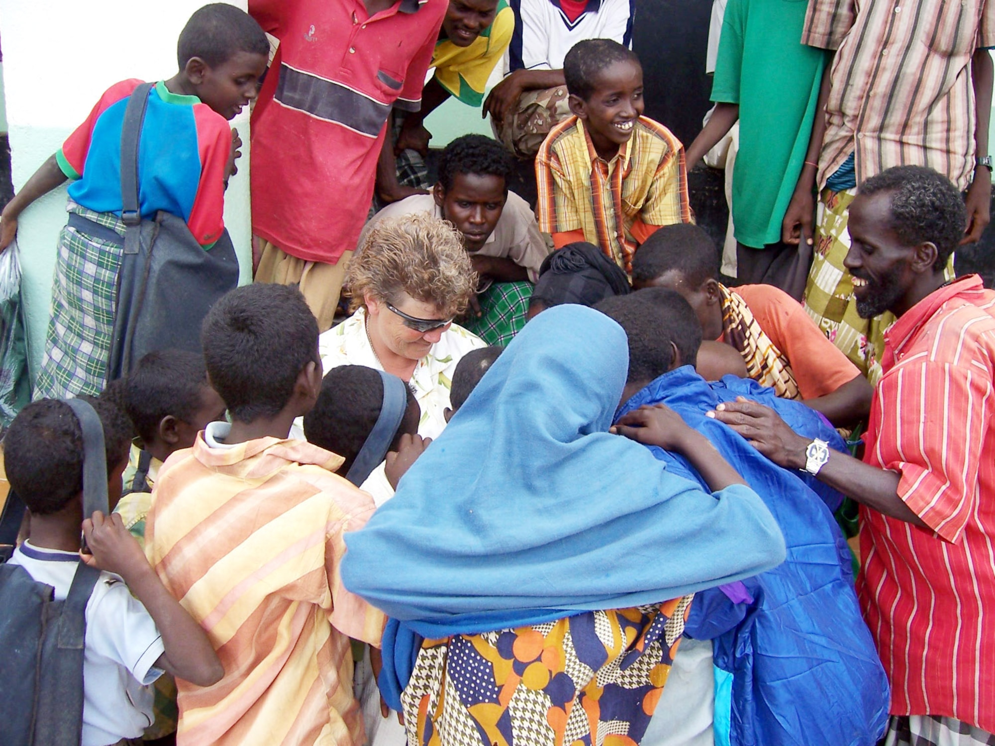 Senior Master Sgt Dawn Fruits shows photographs and video she took of local children in Khor Angar, Djibouti.  Members of the 350th Functional Specialty Team at Camp Lemonier, Djibouti, conducted a site survey to assess medical and health needs in the African village.  Many of the people in this remote village had never seen pictures or video of themselves.  Sergeant Fruits is a paramedic deployed from MacDill Air Force Base, Fla. (U.S. Air Force photo/Army Sgt. 1st Class Marco Jackson