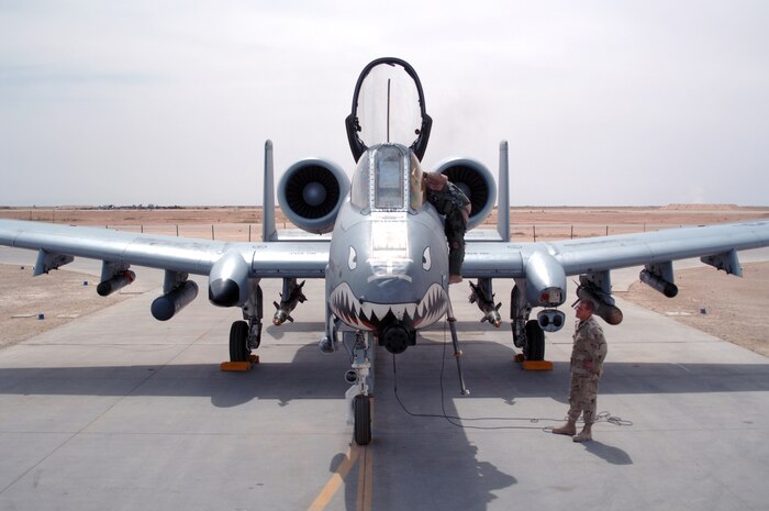 AL ASAD AIR BASE, Iraq — Phenix City, Ala. native crew chief Staff Sgt. Steve Young helps A-10 pilot 1st Lt. Chris "Harpoon" Laird prepare for a combat mission over Al Anbar Province in western Iraq. The lieutenant deployed here with the 74th Fighter Squadron, 438th Air Expeditionary Group, which is assigned to the 332nd Air Expeditionary Wing, the only Air Force wing in Iraq. The group activated Jan. 15, 2007, to provide close air support for Coalition Forces in the region. Within hours of standing up as a fully operational combat flying unit, the group was launching its fierce 'Warthogs' into battle. The A-10's distinctive nose art has been known to strike fear into enemy combatants unlucky enough to see its hungry, shark-toothed facade grinning at them. The Wichita, Kan. native has flown about 30 combat missions in Iraq. (U.S. Air Force photo/Capt. Ken Hall)