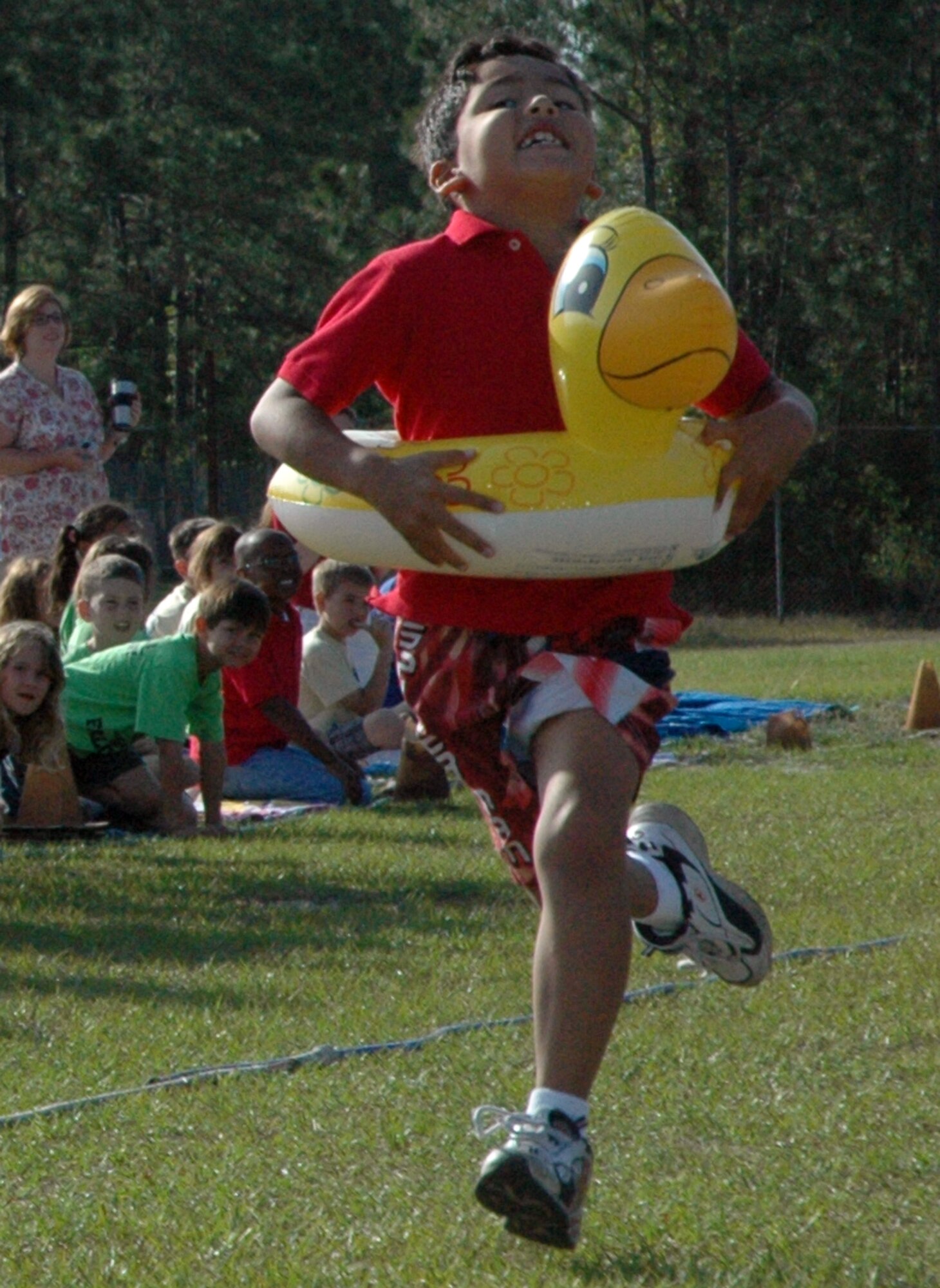 Miguel Mosqueragarcia, 8, runs the “floaty relay” for his team, Roe Rangers, during Tyndall Elementary School’s annual Field Day Thursday. (U.S. Air Force photo by Chrissy Cuttita)