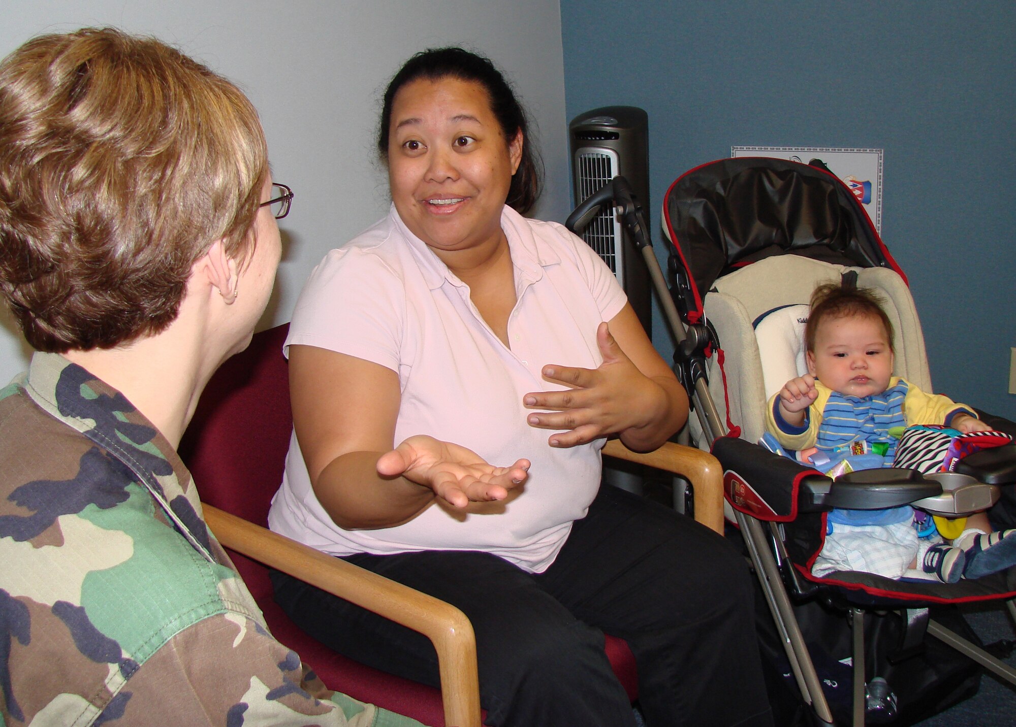 Hearts Apart participant Annette Hunt (center) and her 4-month-old son, Zachary, visit with Tech. Sgt. Bobbie White, 71st Mission Support Squadron readiness NCO. (U.S. Air Force photo/Tech. Sgt. Mary Davis)                              