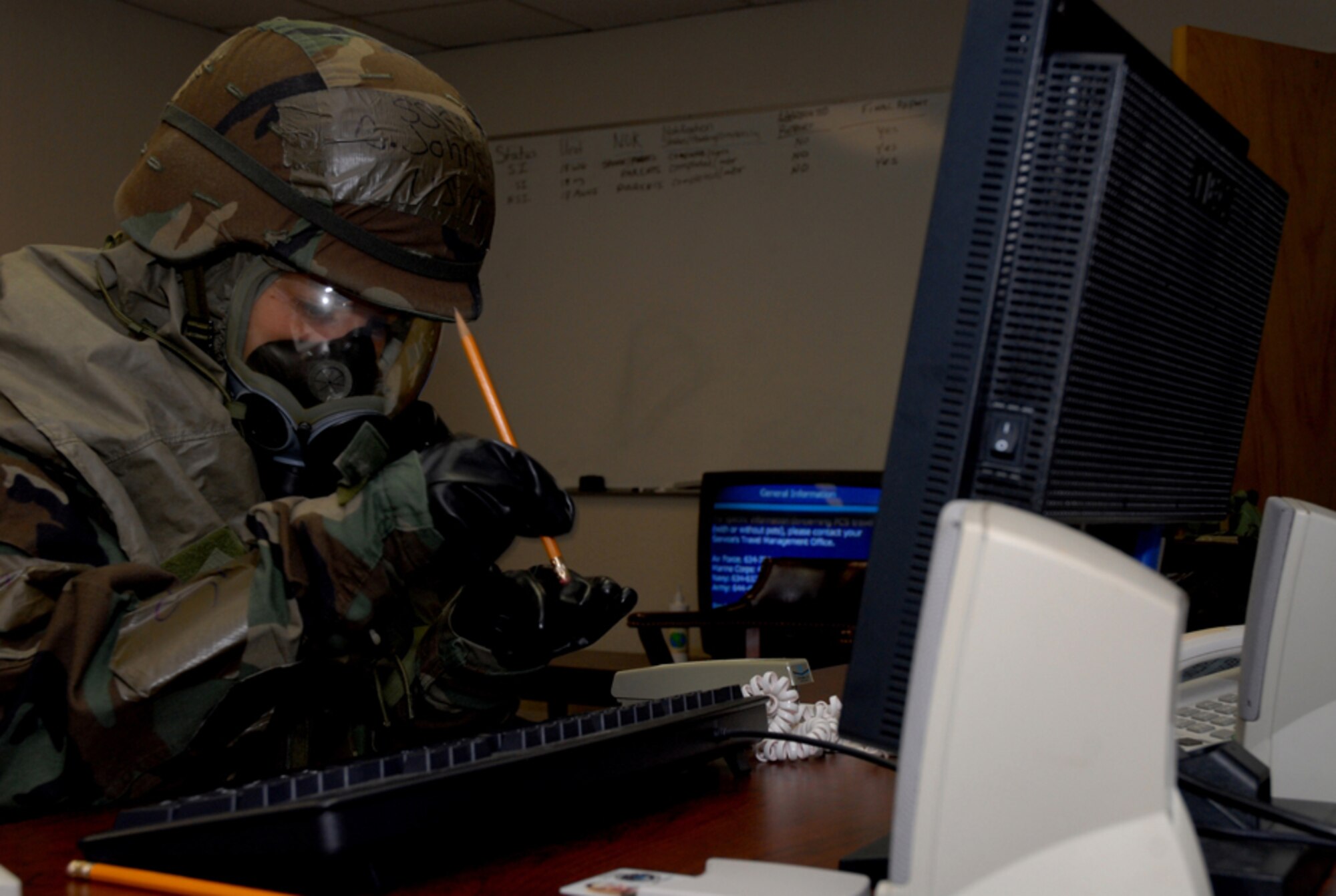 070426-F-9919G-036 
KADENA AIR BASE, Japan -- Staff Sgt. Chrissy Johnson, 18th Mission Support Squadron, updates personnel information while wearing chemical warfare protective equipment.  This was part of week-long exercise activities designed to test the wing's ability to mobilize personnel and cargo, respond to crises, and project combat airpower.  (U.S. Air Force photo Staff Sgt. Joshua Garcia)