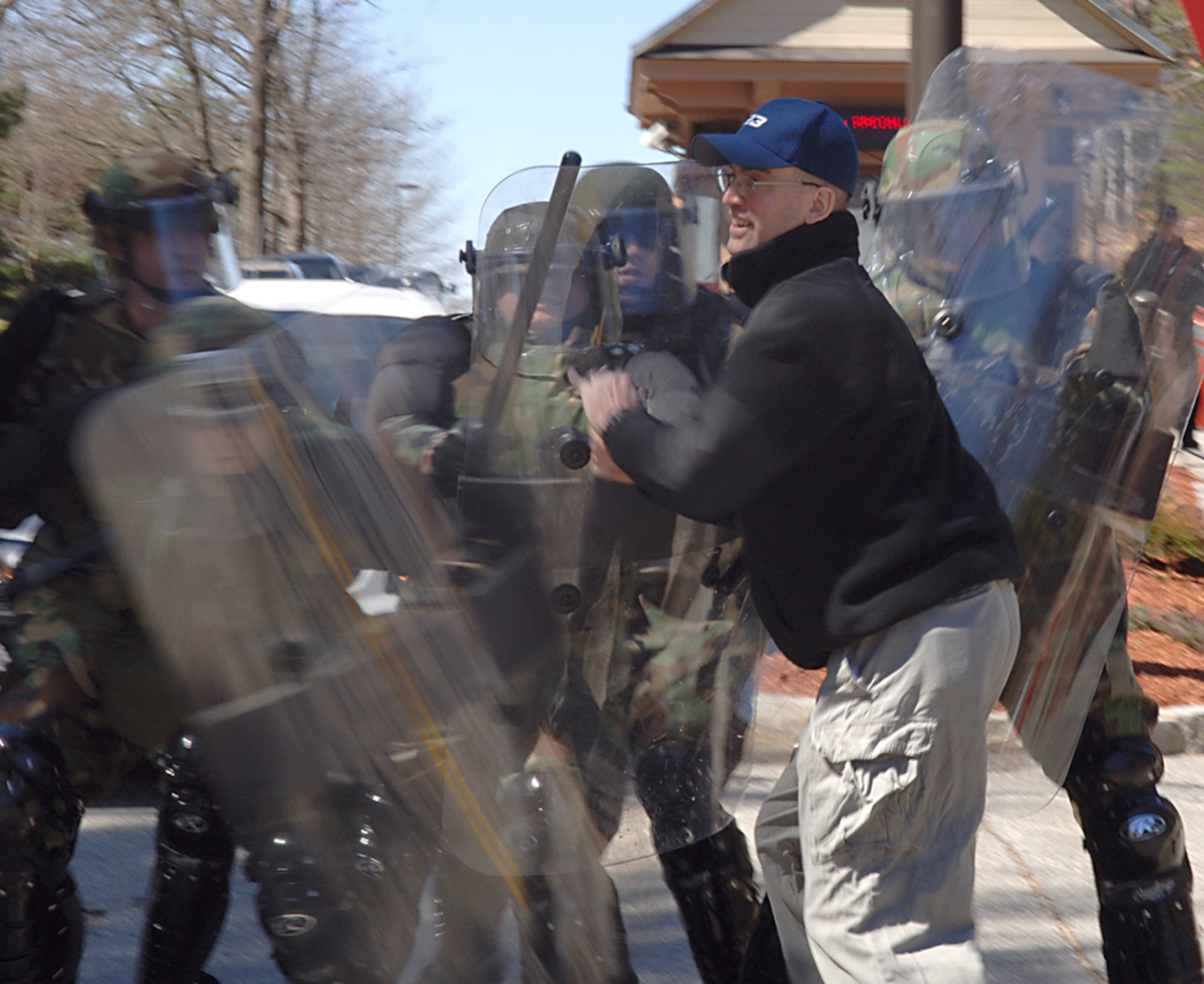 Tech. Sgt. Pete A. Surowiec, 66th Security Forces Squadron Individual Mobilization Augmentee, acts as a violent protester attempting to unlawfully enter Hanscom on April 20 during a squadron-level exercise. (US Air Force photo by Jan Abate)