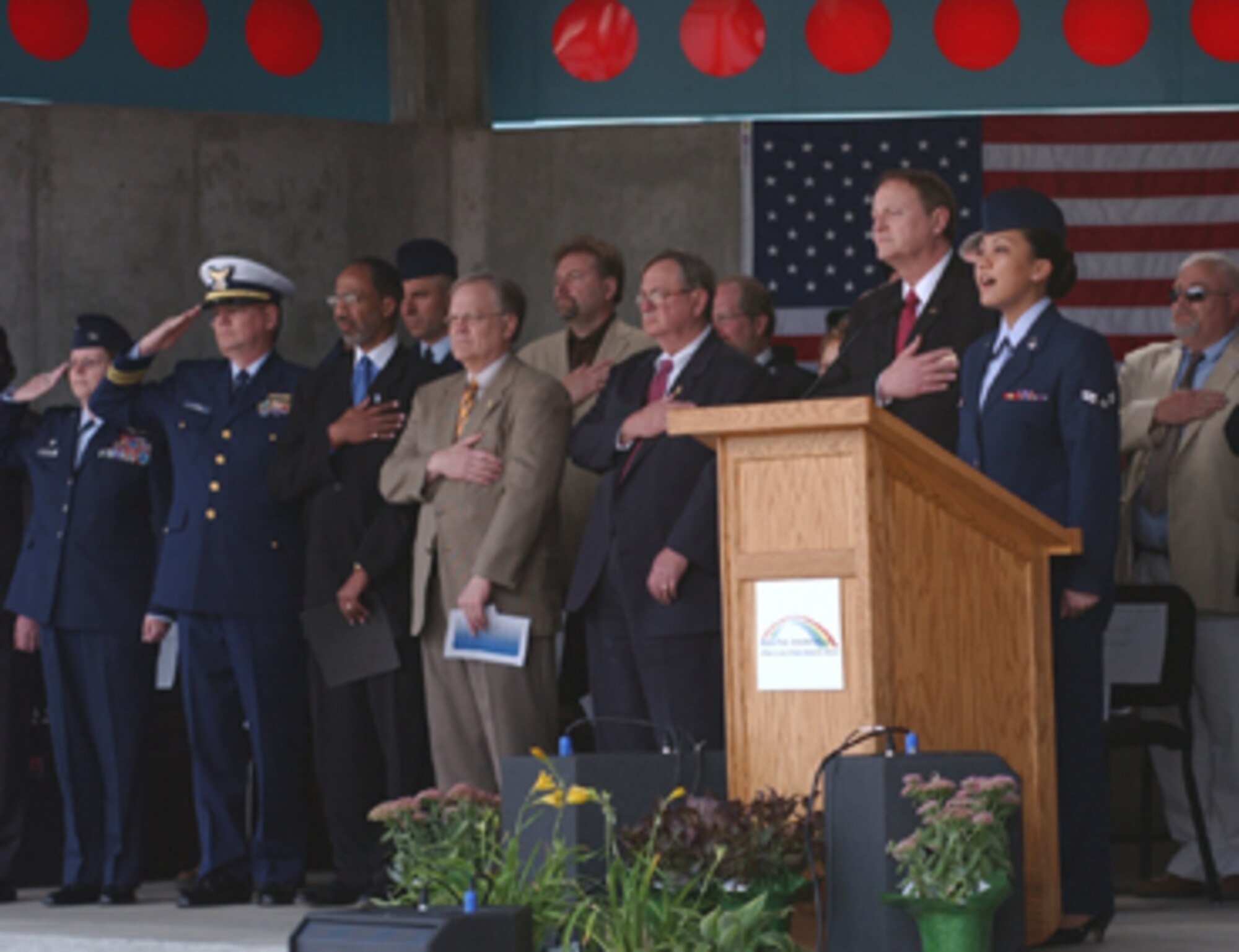 Airman 1st Class Kassandra Toves, 319th Mission Support Services Squadron, sings the national anthem during the Permanent Flood Protection Project dedication April 22 for the historic flood of ’97 commemoration at the town square in downtown Grand Forks, N.D. (U.S. Air Force photo/Airman 1st Class Ashley Coomes)