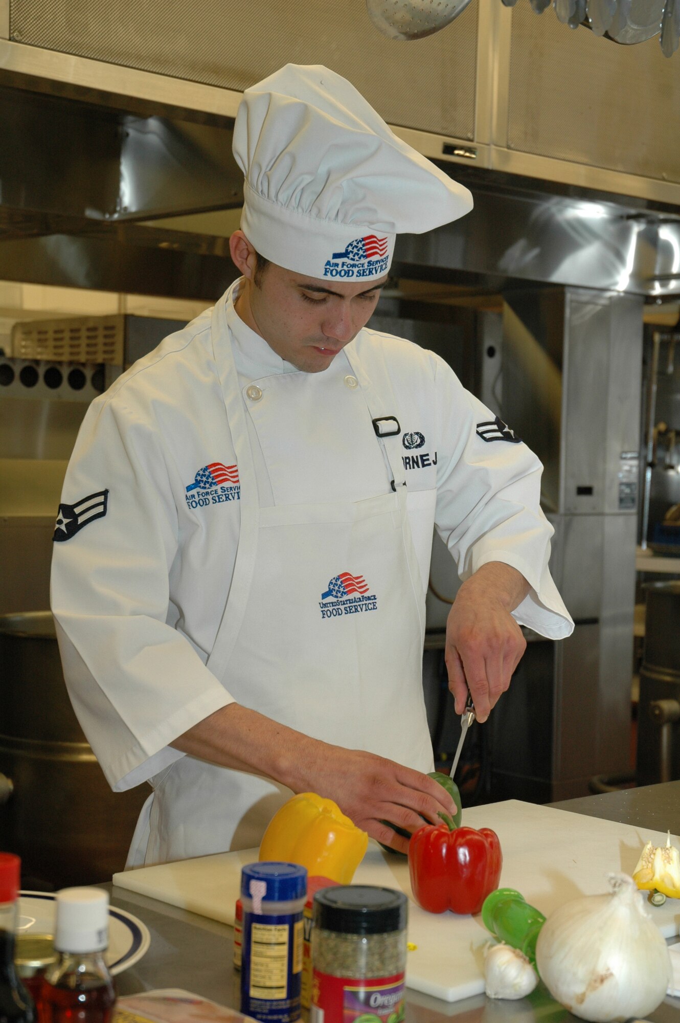 Airman 1st Class Carlos Cornejo, 12th Missile Squadron, gets ready to slice peppers that will be used in his Warrior Chef competition recipe.