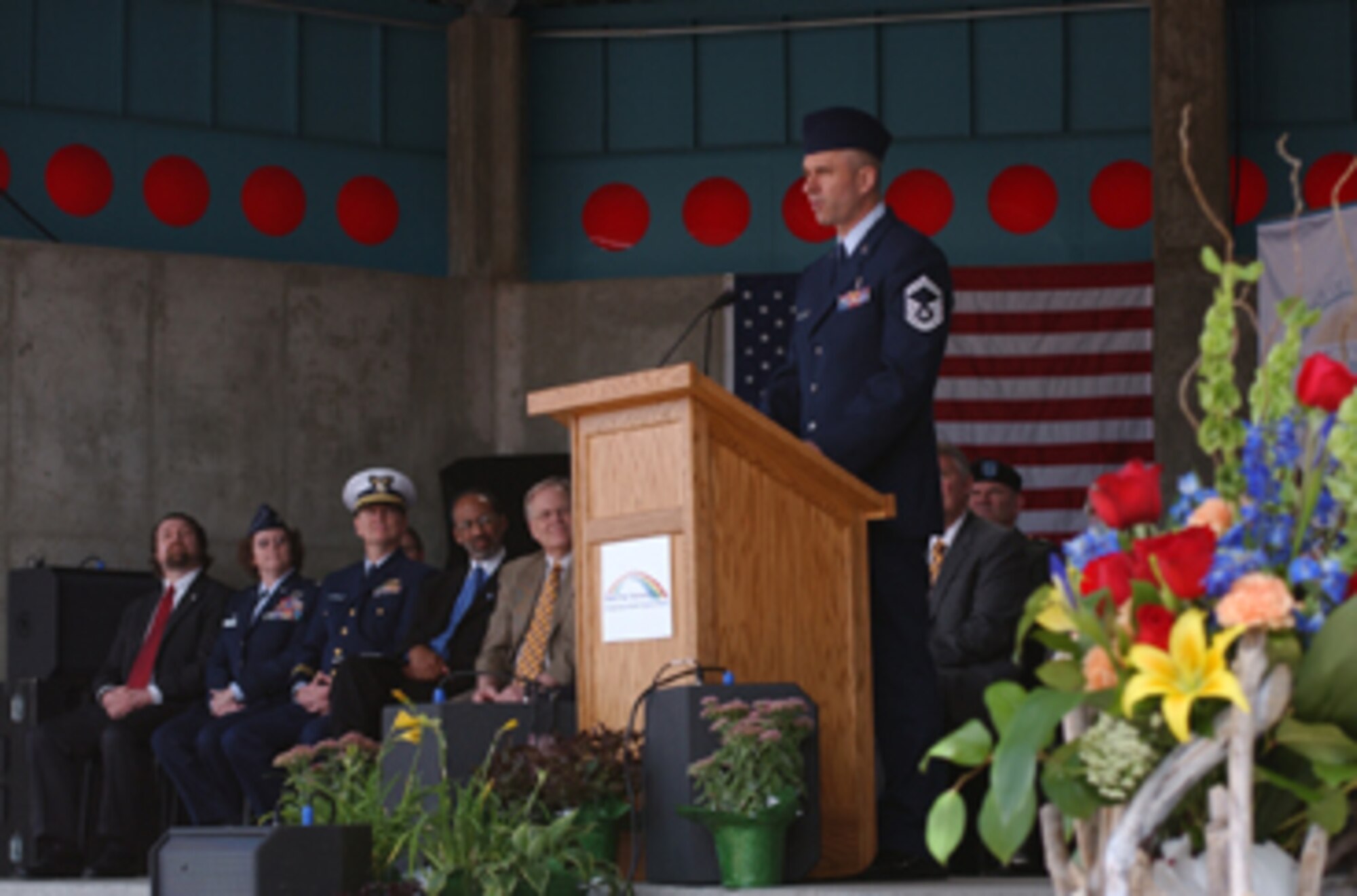 Senior Master Sgt. Ronald Rausch, 319th Medical Group, speaks at the Grand Forks, N.D., Permanent Flood Protection Project dedication April 22 for the historic flood of ’97 commemoration at the town square. He spoke about the base’s involvement during the flood and how the base community and local communities came together to work through the natural disaster. (U.S. Air Force photo/Airman 1st Class Ashley Coomes)