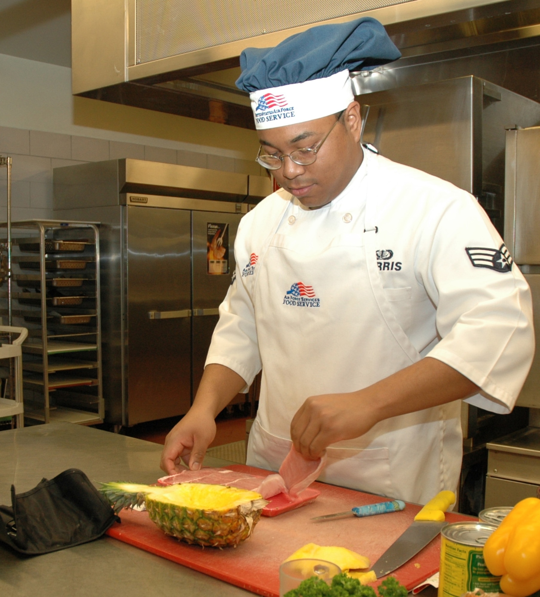 Senior Airman David Harris, 341st Services Squadron, unpacks boneless pork chops that will be used in his recipe.
