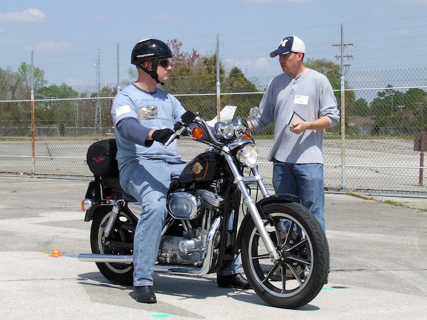 Staff Sgt. Chad Murray, 437th Aircraft Maintenance Squadron Motorcycle Safety Program instructor, talks with Staff Sgt. Jason Anderson, 437th Security Forces Squadron Motorcycle Safety Program student, during the course.(U.S. Air Force photo/Master Sgt. Jeffrey Phipps)